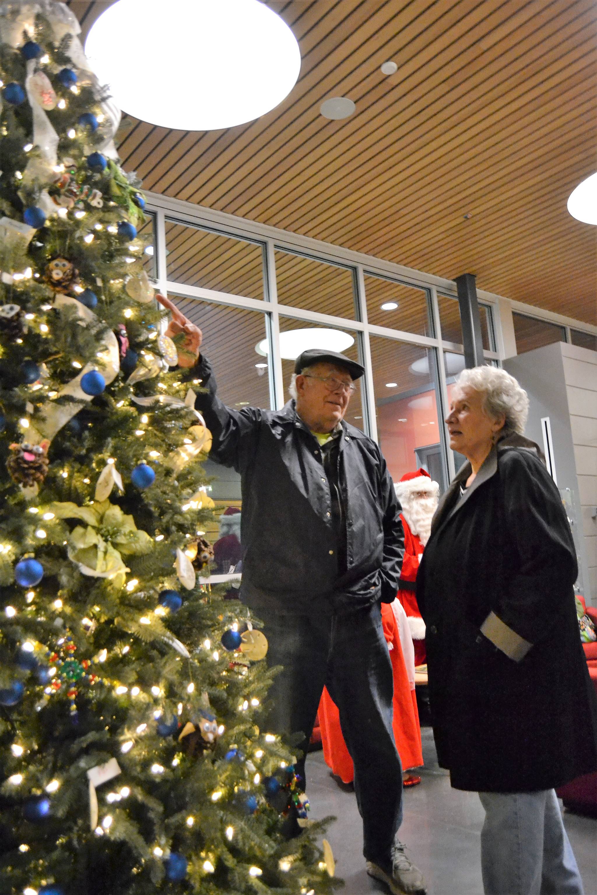 Bob and Elaine Caldwell of Sequim take a closer look at the ornaments on Dec. 1 created for Sequim Civic Center’s Holiday tree by area fourth graders. Sequim Gazette photo by Matthew Nash