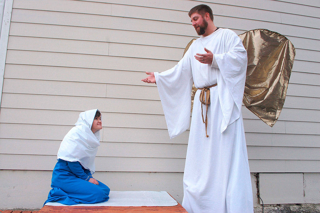 Sequim Valley Nazarene Church, 481 Carlsborg Road in Sequim, continues its free Living Nativity tours this Saturday every hour at 4, 5, 6 and 7 p.m. on Dec. 16. Above, Actors Natalie Luengen as Mary and David Merrikin as an angel reenact a scene from the Christmas story. The guided tour lasts about 40-45 minutes going through six scenes of the Christmas story with live actors and an array of animals. Guests may park at Greywolf Elementary School near the intersection of Carlsborg and US Highway 101 and will be bused to the church from the school. The church asks guests plan to arrive at least 15 minutes before each tour. For more information, visit www.sequimchurch.org. Sequim Gazette photo by Erin Hawkins