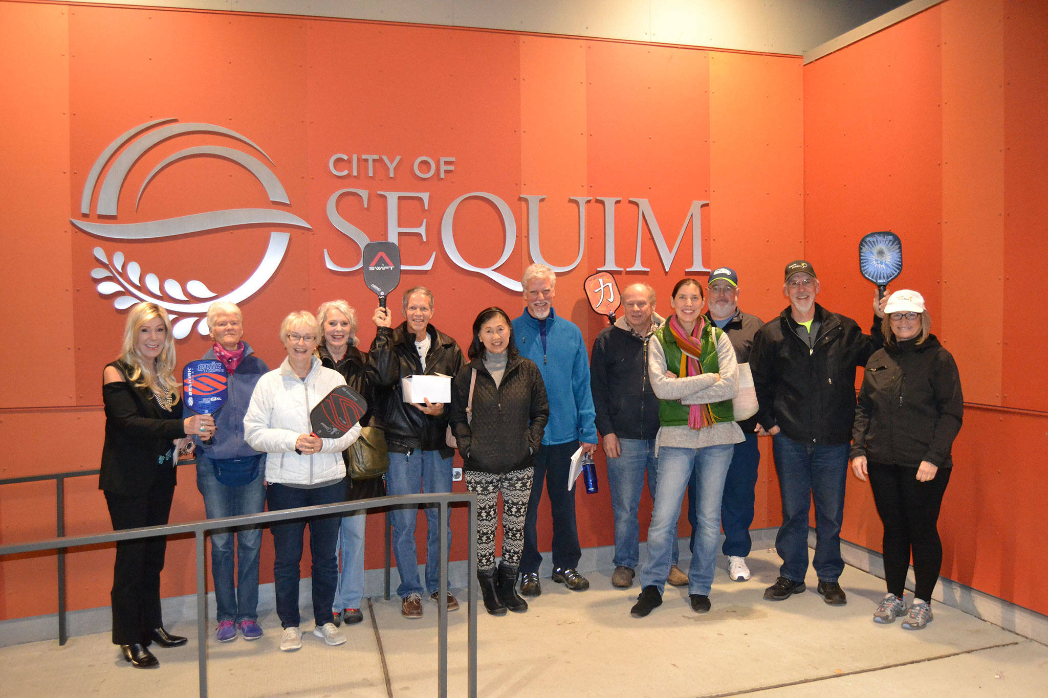Some of the members of the Sequim Picklers pickleball group stand outside the Sequim Civic Center on Dec. 11 to celebrate city councilors approving a contract to build eight new courts in Carrie Blake Community Park tentatively by June. Sequim Gazette photo by Matthew Nash