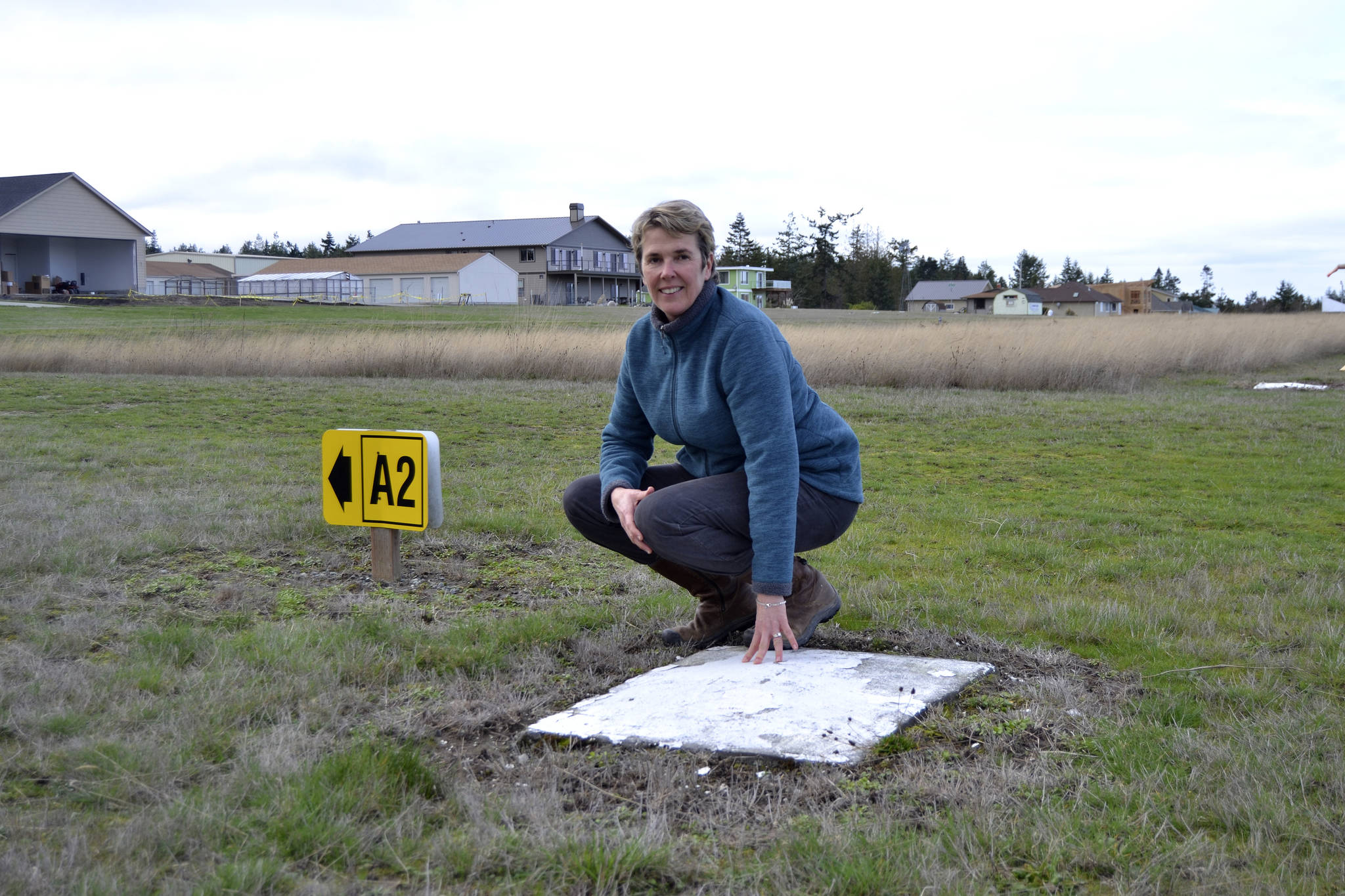 Kaye Gagnon, volunteer for the Diamond Point Airport Association, stands near one of the four corners of the Diamond Point Airport’s helipad. Airport Association members seek up to $8,000 to support paving the helipad to make it safer for airlifts. Sequim Gazette photo by Matthew Nash