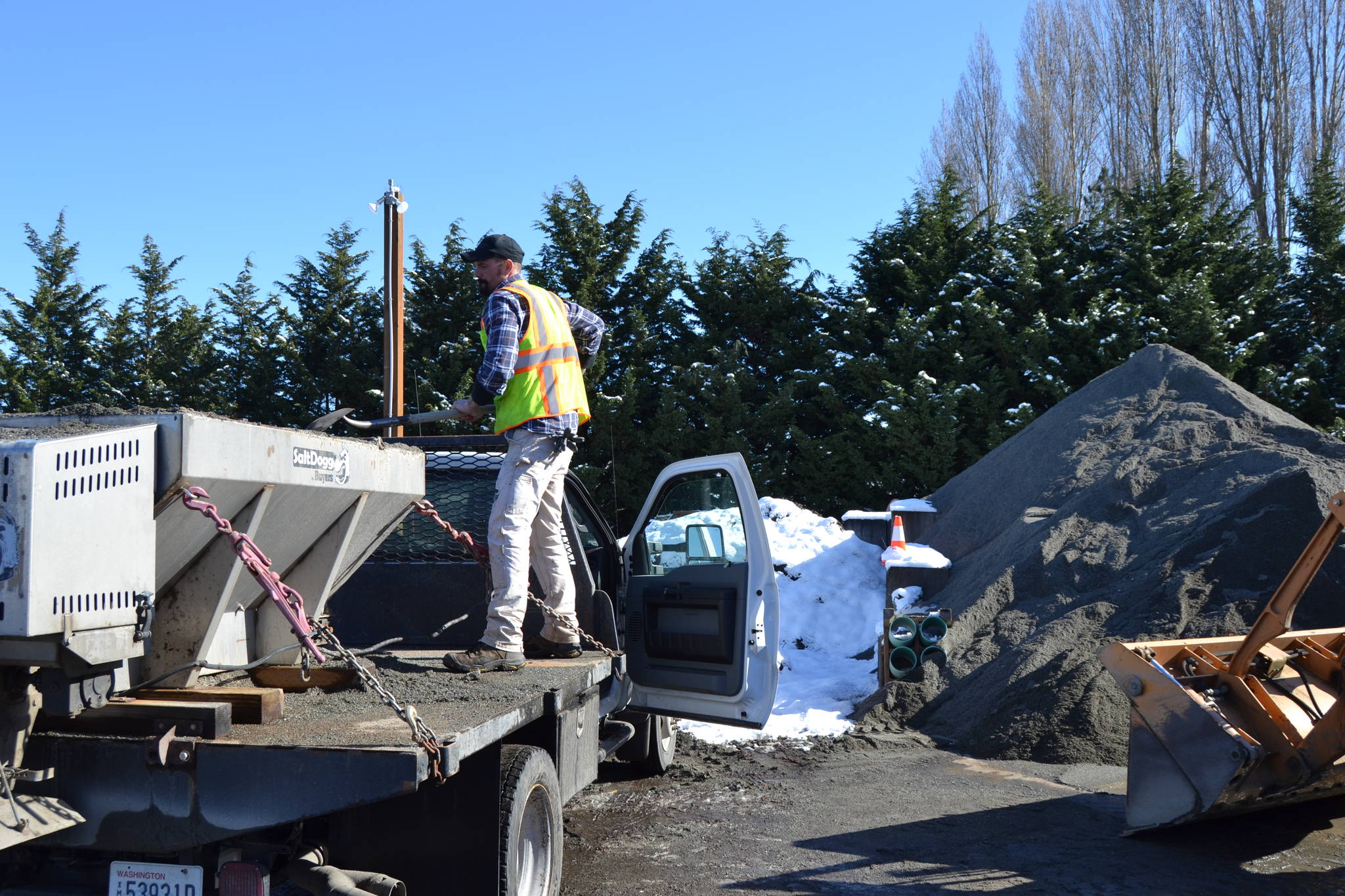 Hank Arnold, a maintenance worker for the City of Sequim, loads sand into his spreader at the City Shop before taking to the city streets to make roadways safer to drive on Feb. 23. Arnold drove one of five city trucks with plows and sand spreaders during the recent snowfall. Sequim Gazette photo by Matthew Nash