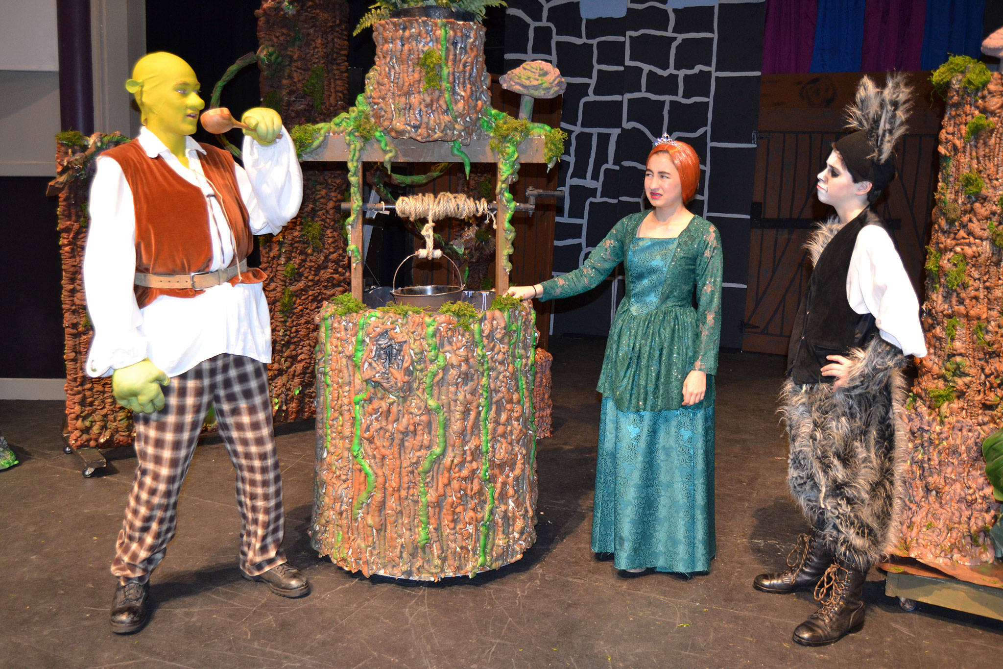 Shrek (Ashton Smith) takes a drink while Princess Fiona (Kariya Johnson) and Donkey (Ayden Humphries) wait for him to finish. The trio star in Sequim Middle School’s production of “Shrek the Musical Jr.” on March 8-10 at Sequim High School. Sequim Gazette photo by Matthew Nash