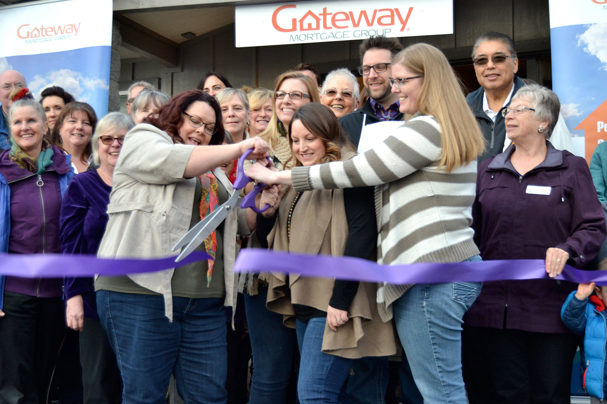 Staff with Sequim’s Gateway Mortgage Group, from front left, Deon Kapetan, Amy Phillips, Stephanie Sweet, and Jennifer Sweeney, cut the ribbon for the Sequim-Dungeness Chamber of Commerce to celebrate the Gateway’s grand opening on March 9. Sequim Gazette photo by Matthew Nash