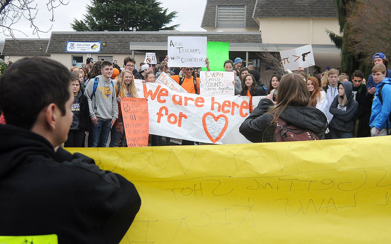 About 100 Sequim High School students take a break from classes to express their views about gun control laws during the National School Walkout on Wednesday, March 14. Along with students across the country, SHS students offered up a variety of views on the school campus at 10 a.m. for a 17-minute demonstration — one minute for each of the 17 people killed at Florida’s Marjory Stoneman Douglas High School one month ago. Sequim Gazette photo by Michael Dashiell