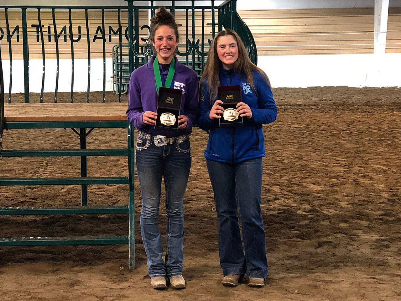 Sequim’s Yana Hoesel, left, celebrates a District 4 Reserve Champion Timed Events buckle, alongside champion Cassi Ann Moore of Port Angeles. Submitted photo