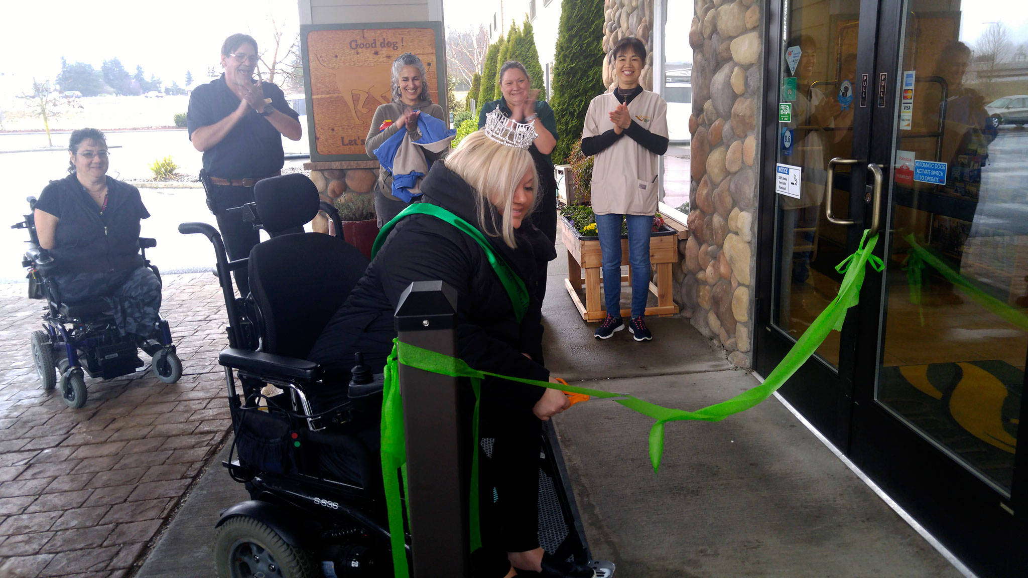 Ms. Wheelchair Washington Stacie Lee cuts the ribbon on new automated doors at Quality Inn & Suites in Sequim. Submitted photo