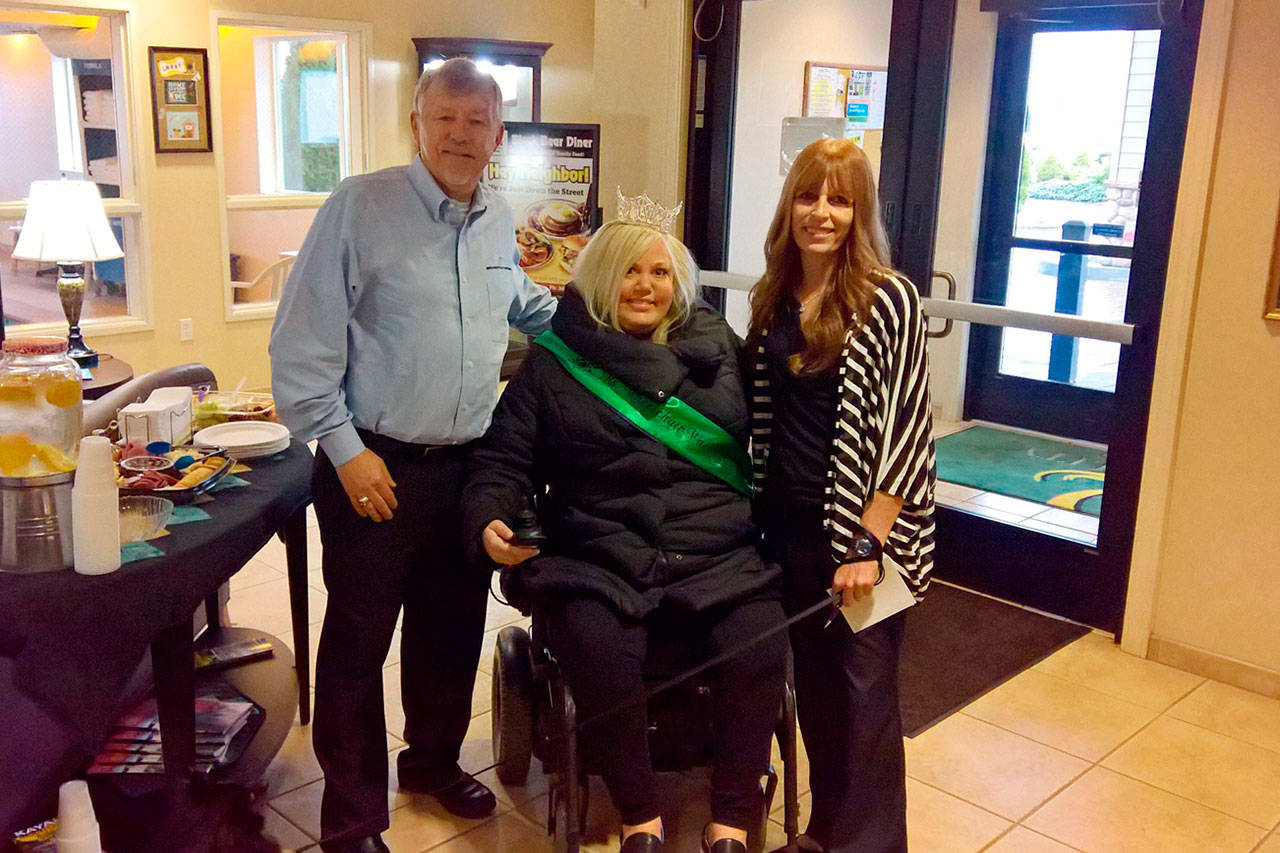 Ms. Wheelchair Washington Stacie Lee poses for a photo after cutting the ribbon at Sequim Quality inn & Suites with its owner Bret Wirta and General Manager Nancy Merrigan. Submitted photo