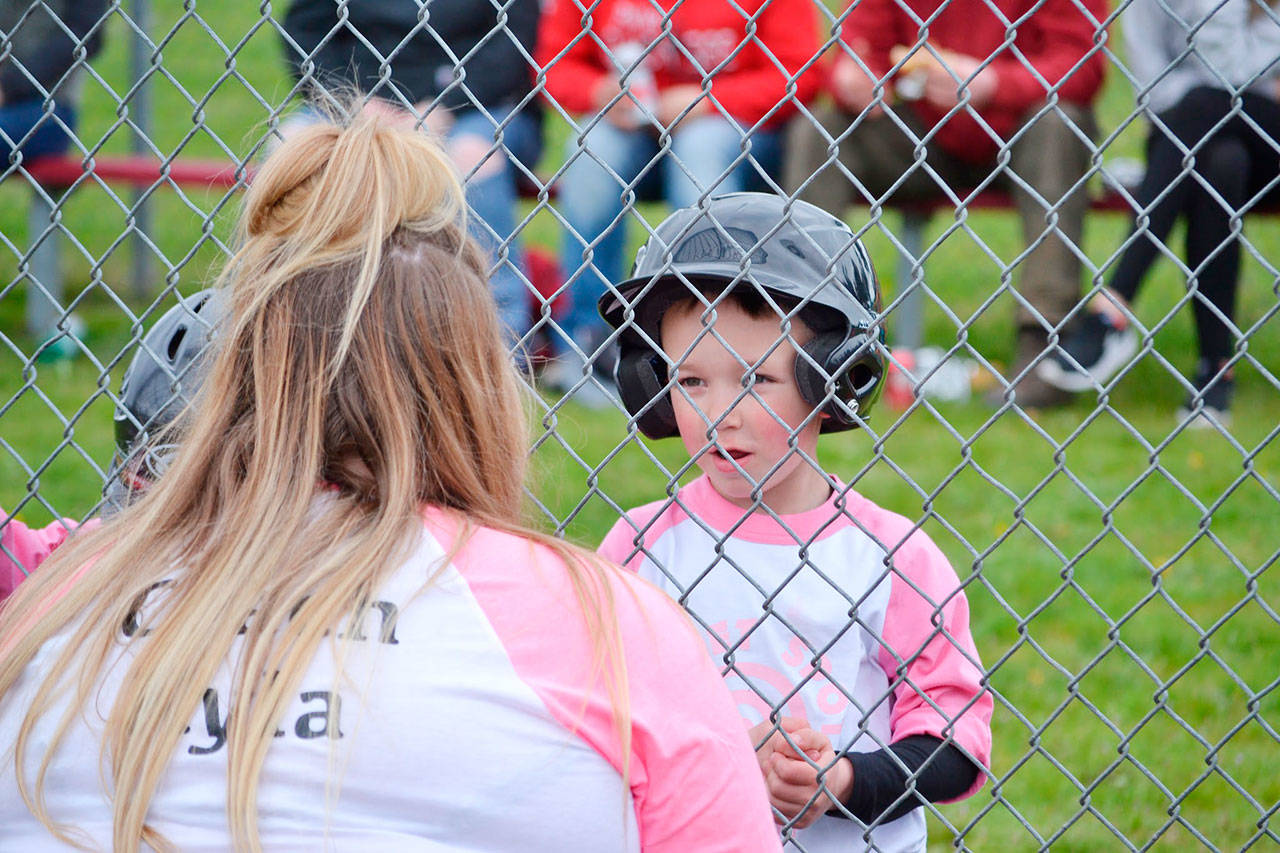 Coach Kyla Rigg of Sweet Spot speaks with Levi Hull before an at-bat on April 14, Sequim Little League’s Opening Day. Sequim Gazette photo by Matthew Nash