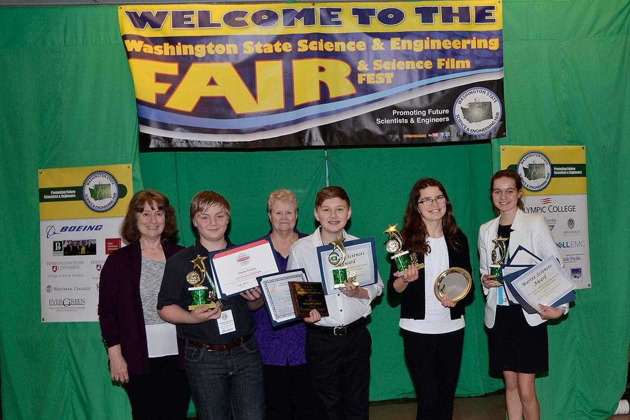 Sequim students in grades 7-10 celebrate top finishes at the Washington State Science and Engineering Fair on March 23. Pictured, from left, are mentor Debra Beckett, Chase Swartz, mentor Mary Omberg, Richard Meir, Karlie Viada and Vita Olson. Not pictured are Keyana Cundiff and Paola Villegas. Submitted photo