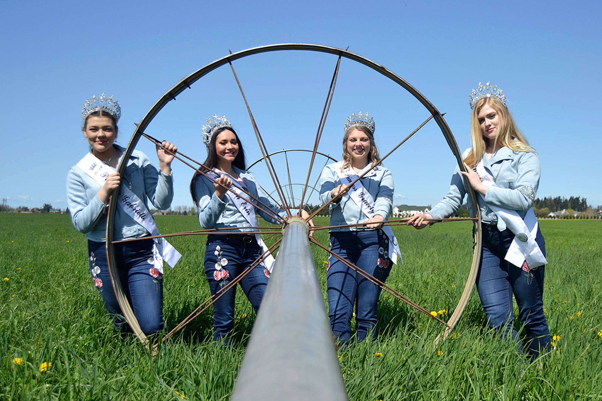 Sequim Irrigation Festival royalty, from left, Princess Gabi Simonson, Queen Erin Gordon, Princess Gracelyn Hurdlow, and Princess Eden Batson stand by a sprinkler on the Dick Family Farm during a photo shoot for the festival’s programming. Sequim Gazette photo by Matthew Nash
