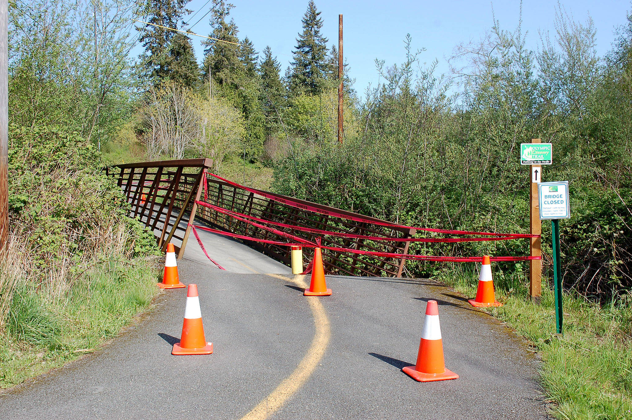 In mid-April, a portion of the Dean Creek bridge in Blyn sunk due to high water leading officials with the Jamestown S’Klallam Tribe and the Peninsula Trails Coalition to close it. No timetable has been set for its repair. Sequim Gazette photo by Erin Hawkins