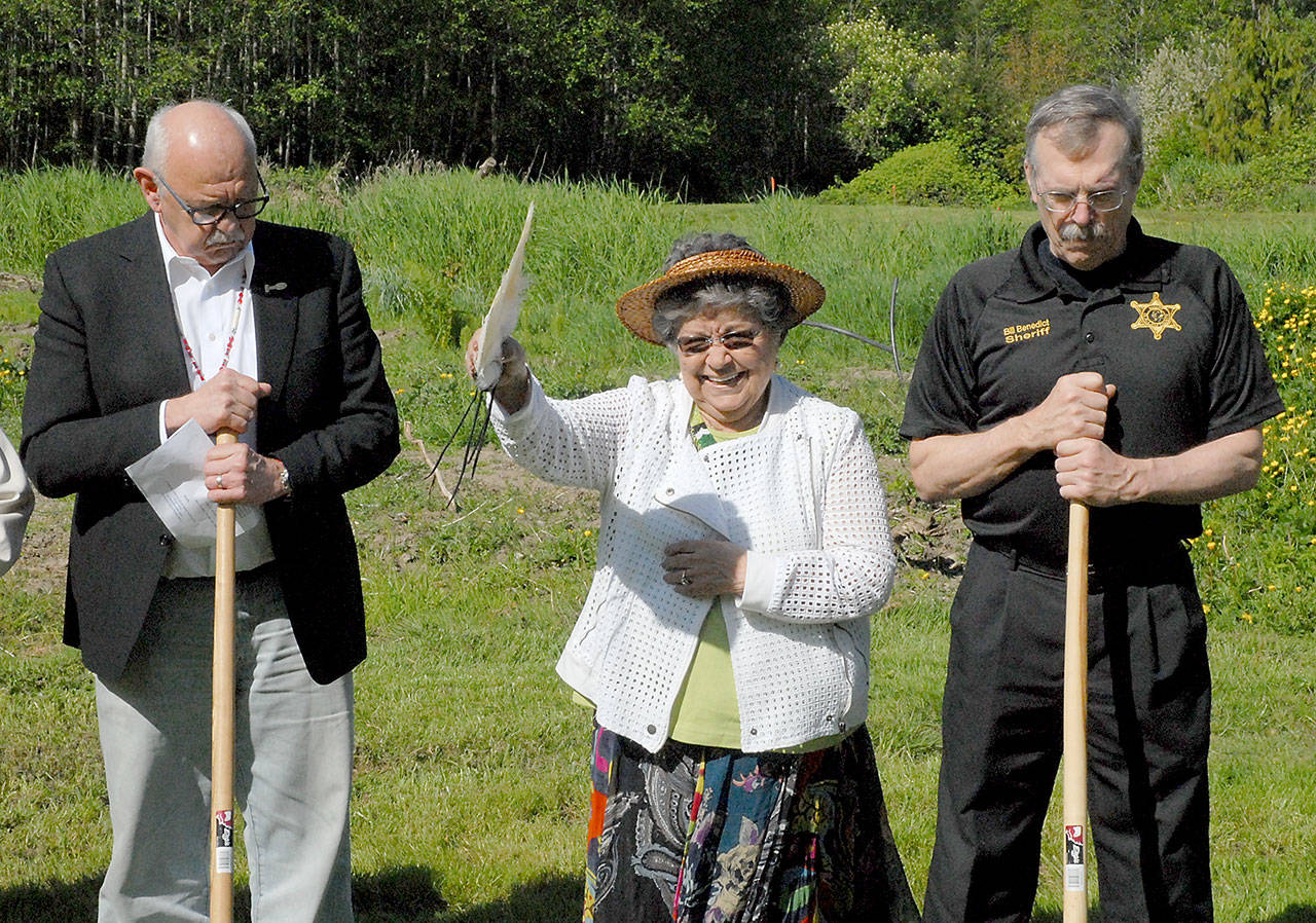 Jamestown S’Klallam tribal elder Elaine Grinnell, center, gives a blessing over the site of the tribe’s future public safety and justice center in Blyn while surrounded by the tribal council Chairman Ron Allen, left, and Clallam County Sheriff Bill Benedict on Saturday. Photo by Keith Thorpe/Peninsula Daily News