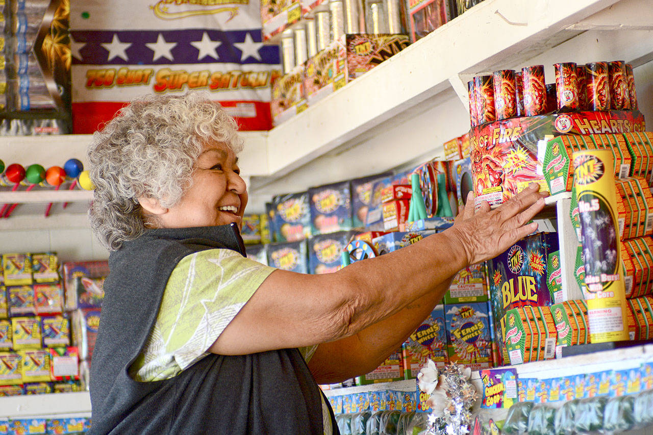 Margie Macias arranges fireworks at her fireworks stand, Margie Fireworks, on the Lower Elwha Klallam Tribe reservation in 2017. Photo by Jesse Major/Peninsula Daily News