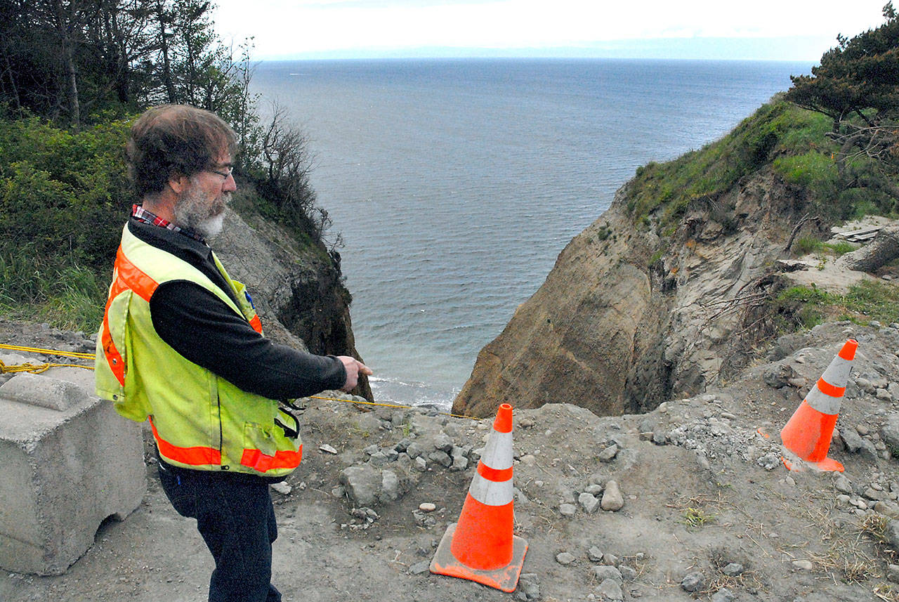 Assistant Clallam County engineer Joe Donisi looks over an eroded section of bluff caused by a damaged drainage culvert under West Bluff Road in The Bluffs neighborhood between Sequim and Port Angeles on May 10. Photo by Keith Thorpe/Peninsula Daily News