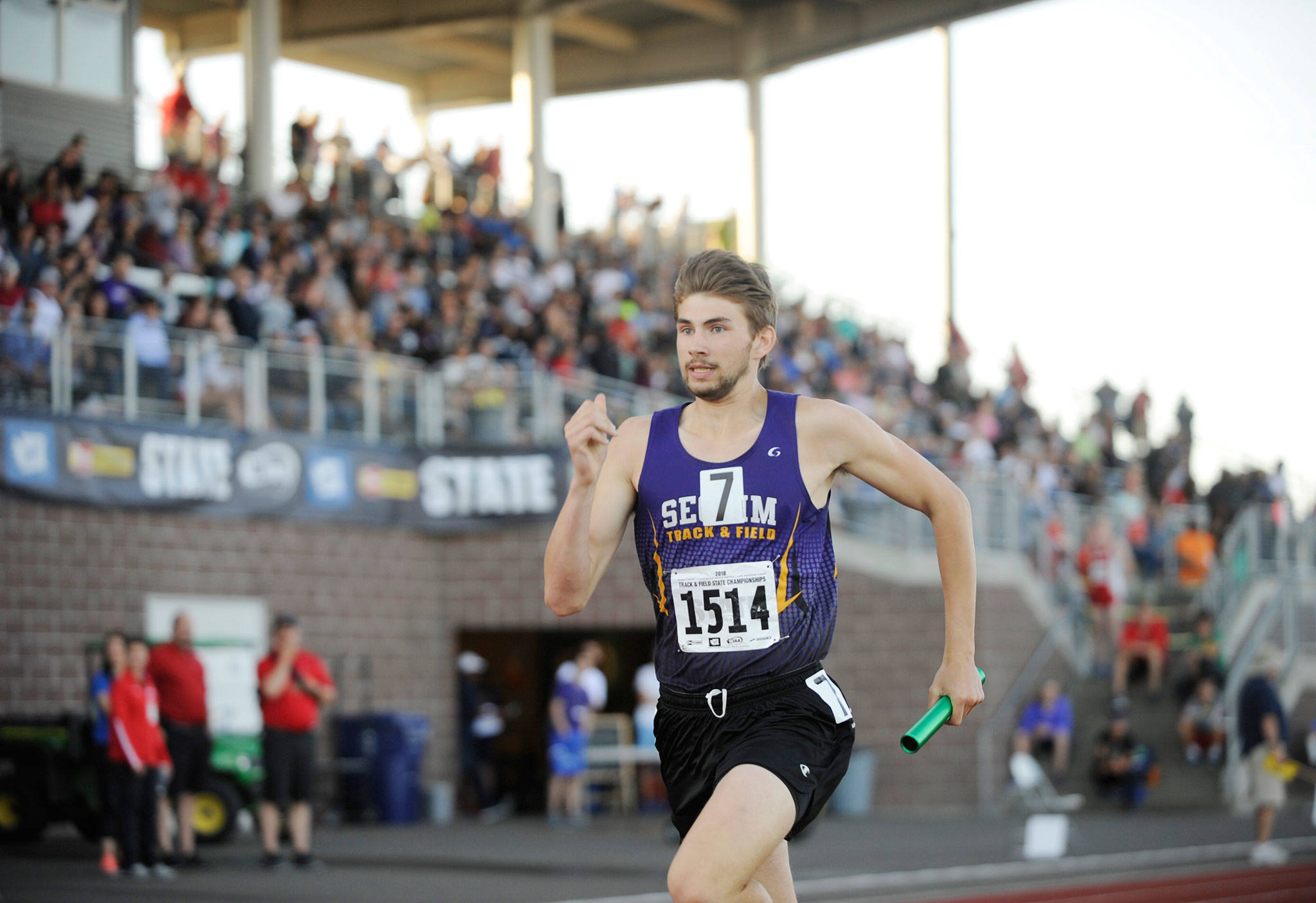 Sequim’s Alec Shingleton finishes off Sequim’s 4x400 relay in preliminaries on Thursday, May 24, at the class 2A state track and field championships in Tacoma. With Logan Laxson, Murray Bingham, Darren Salazar and anchor Shingleton competing, the Wolves took third in their heat with a 3:25.40 and qualified for the finals. Sequim Gazette photo by Michael Dashiell