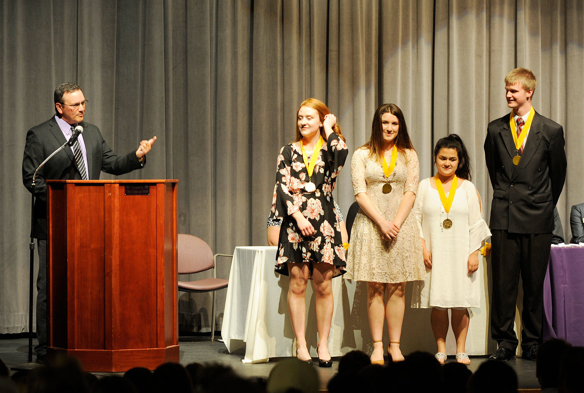 Sequim High School principal Shawn Langston, left, introduces SHS’s four Class of 2018 valedictorians: (from left) Kiara Pierson, Audrey Hughes, Grace Tolberd and Jazz Weller. Sequim Gazette photo by Michael Dashiell