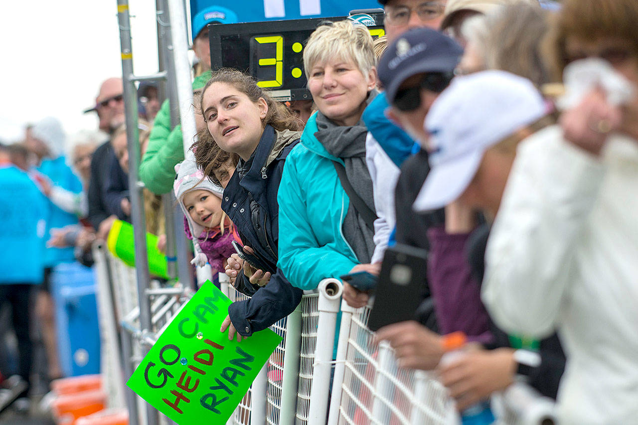 Spectators watch on as runners make their way toward the finish line at the North Olympic Discovery Marathon on Sunday. (Jesse Major/Peninsula Daily News)