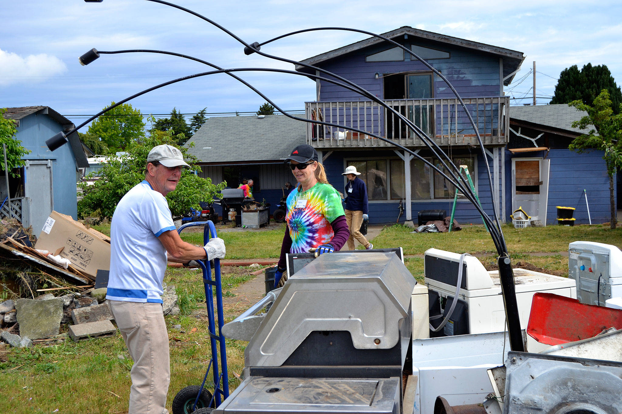 Rick Reed of Dallas, Texas, and Andrea Putnam of Princeton, NJ., move a dryer during Sequim Service Fest’s first house clean-up on June 5. Both Reed and Putnam plan to stay and volunteer in Sequim through the event’s finish on June 15. Sequim Gazette photos by Matthew Nash