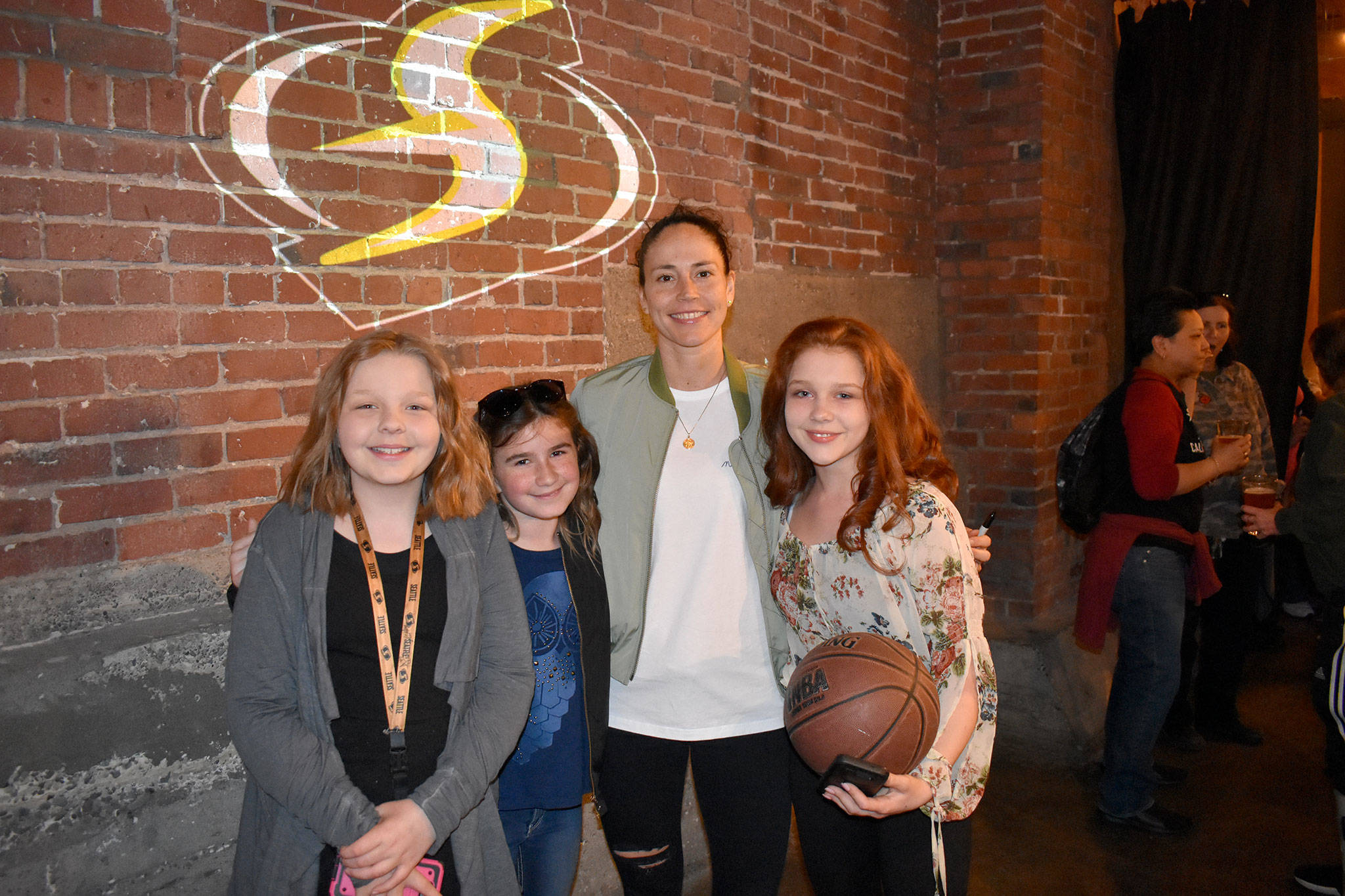 In photo at left, Sequim’s Destinie Bernard, left, and sisters Pearl and Lily Peterson stand with Seattle Storm guard Sue Bird for a photo on June 5 at a VIP experience in Seattle. Photos courtesy of Dave Miller