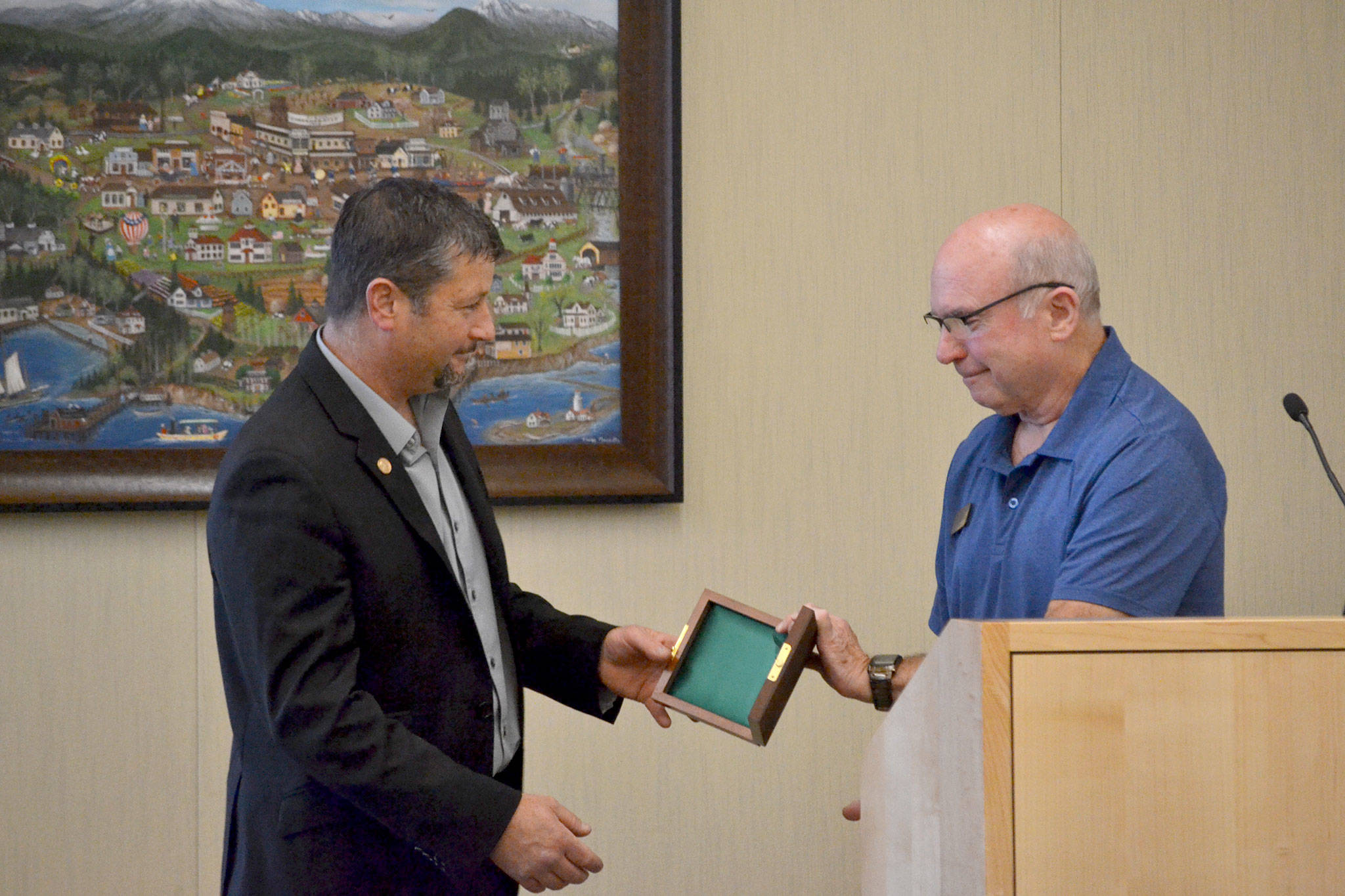 Jason Doig of Sequim accepts the Carnegie Medal from Sequim Mayor Dennis Smith on June 25 for his efforts to save a woman from jumping off a railing on the Hood Canal Bridge on March 3, 2017. “I think I did what a lot of people in this room would have done,” Doig said. Sequim Gazette photo by Matthew Nash