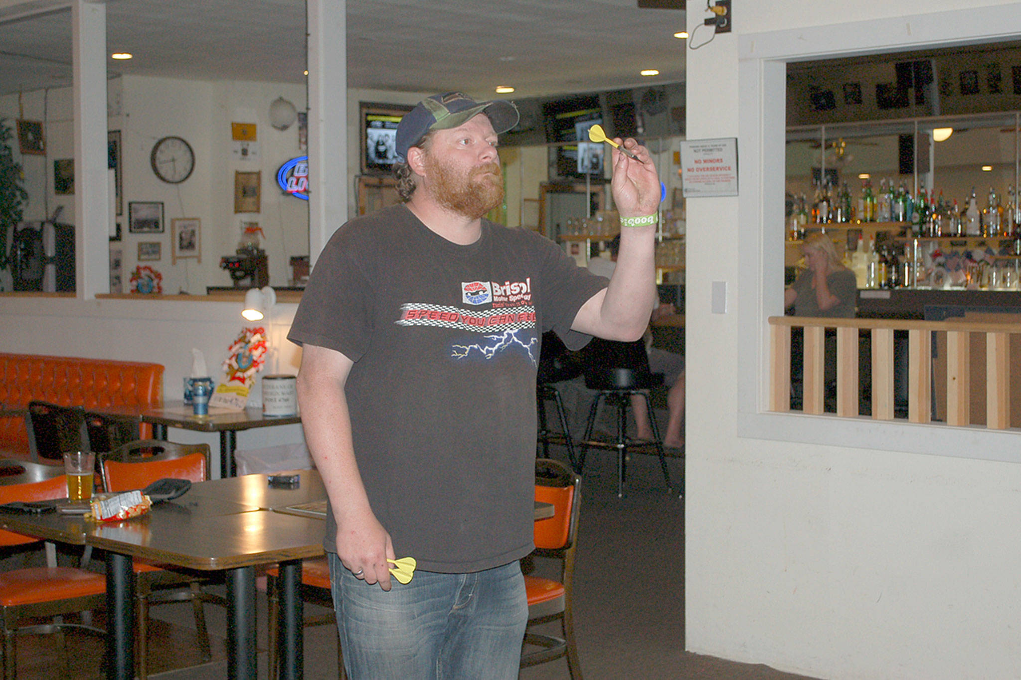 Jimmy Shaumburg lines up for his turn during Dart League at the Veterans of Foreign Wars Post 4760’s club bar and canteen room, one of several recreational activities offered at the facility. Sequim Gazette photo by Erin Hawkins