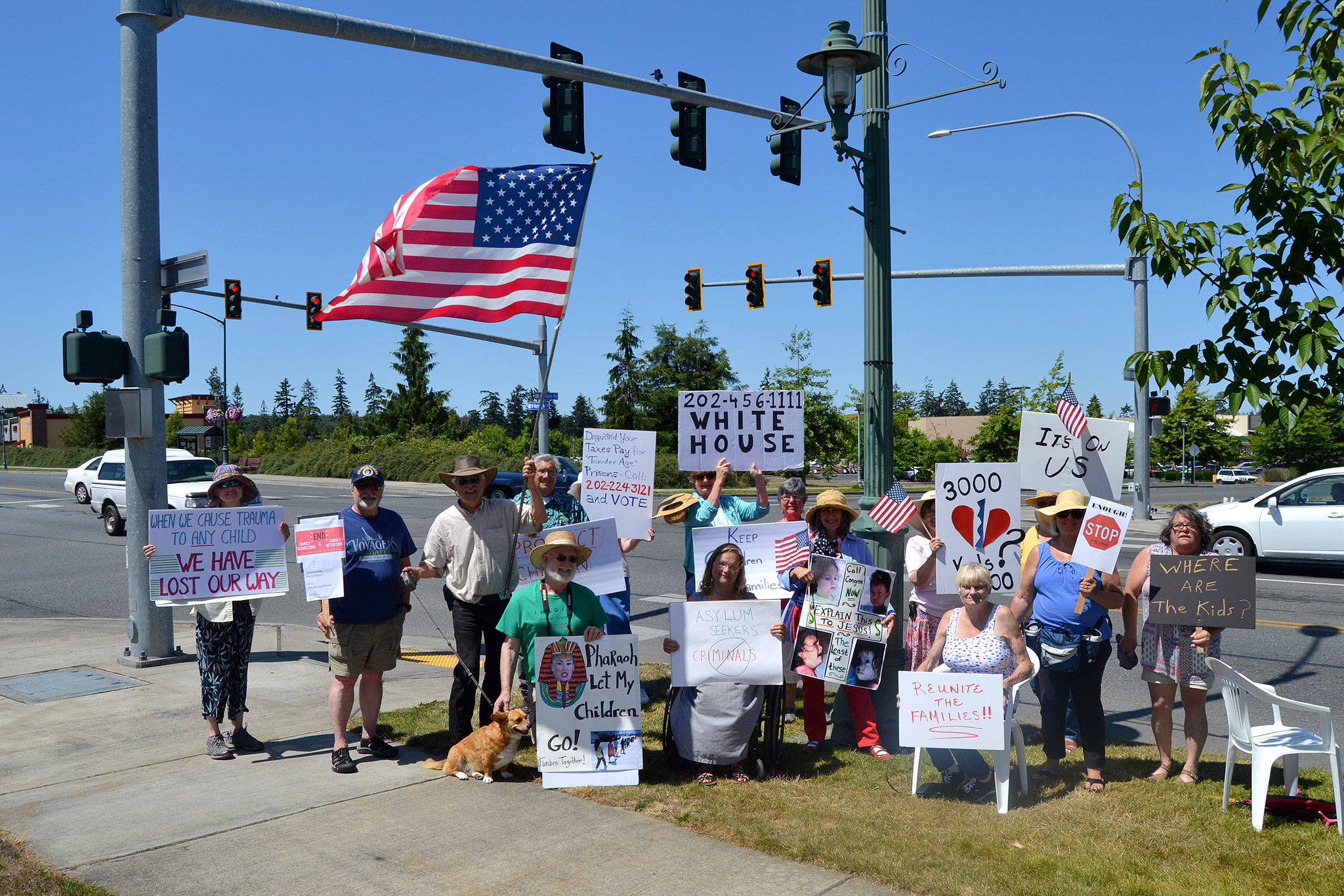 Community members gather July 15 for the fourth Sunday asking government officials to reunite all migrant children with their families separated at the US/Mexico border. Sequim Gazette photo by Matthew Nash