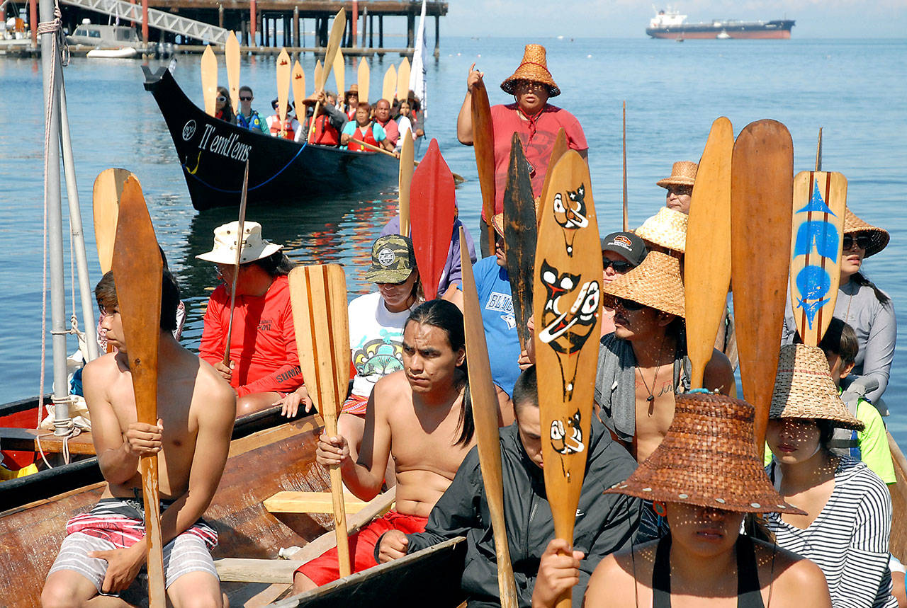 Keltsmaht Thomas of Ahousaht First Nations on Vancouver Island, standing at rear, asks for permission to come ashore at Hollywood Beach in Port Angeles on July 20, as a canoe belonging to Klahoose First Nation approaches behind him. Photo by Keith Thorpe/Peninsula Daily News