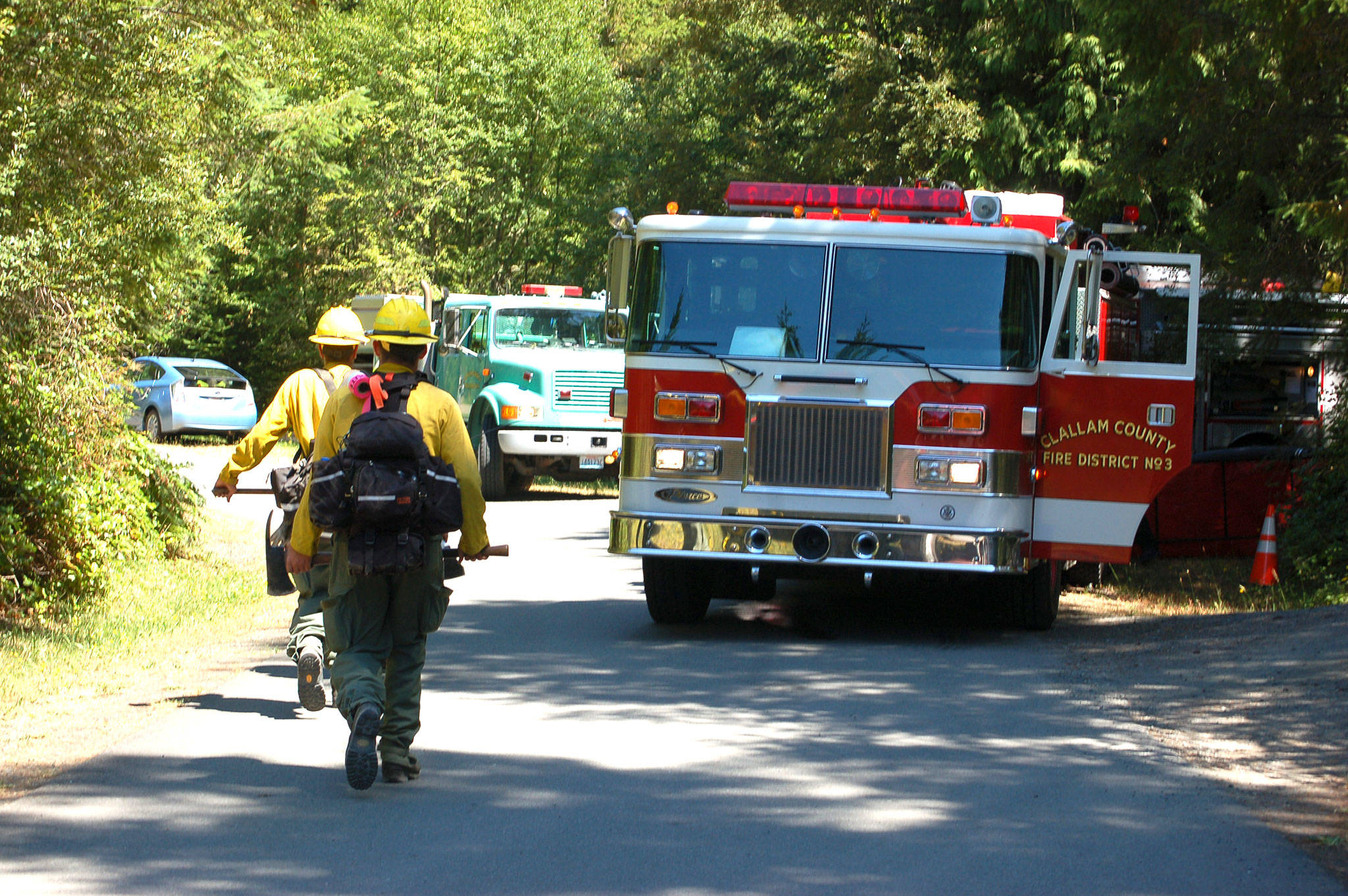 Clallam County Fire District No. 3 and the Department of Natural Resources responded to a brush fire near East Sequim Bay Road on July 25. The fire was contained to less than an acre by 1:30 p.m. and the cause is under investigation. Sequim Gazette photo by Erin Hawkins