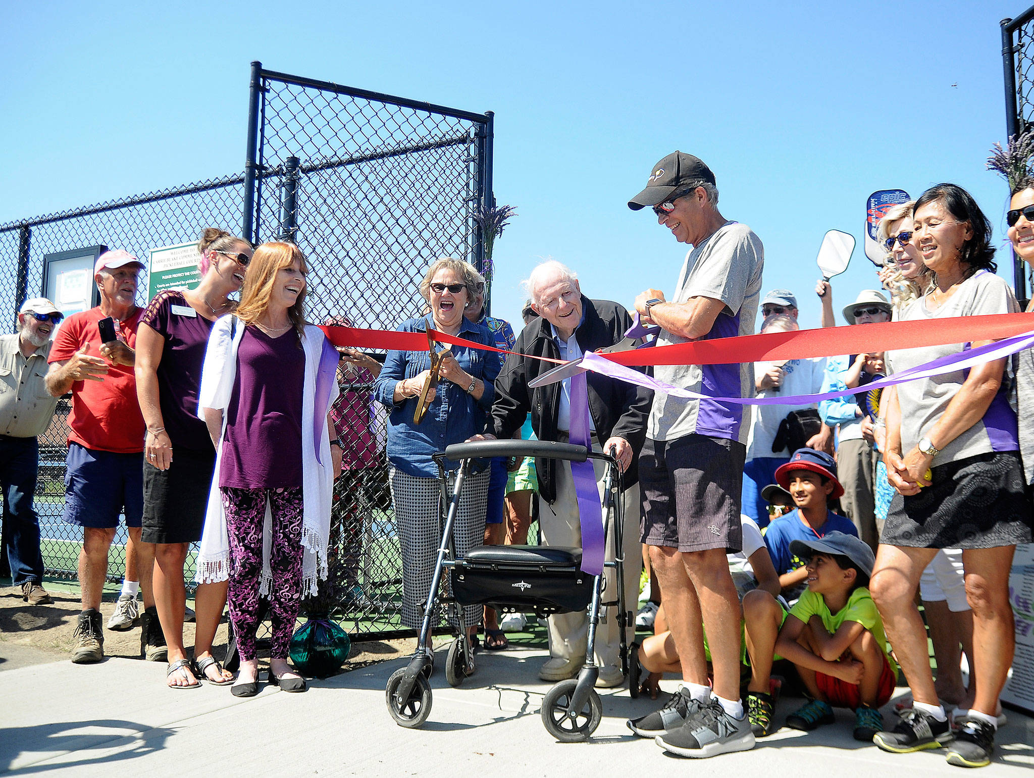 Sequim Picklers and other pickleball advocates celebrate the grand opening of courts at Carrie Blake Community Park last week. Pictured, from left, are: Nancy Merrigan, Sequim-Dungeness Chamber of Commerce board member, City of Sequim councilor Candace Pratt; Barney McCallum, one of three originators of the sport of pickleball, and Charlie Pugh, vice president for the Sequim Picklers group. Sequim Gazette photo by Michael Dashiell
