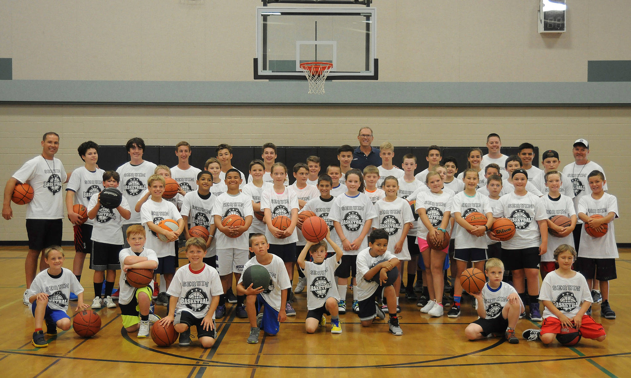 Former NBA star Kurt Rambis (back row, center) joins Sequim Youth Basketball players at their camp in Sequim on July 27. Sequim Gazette photos by Michael Dashiell