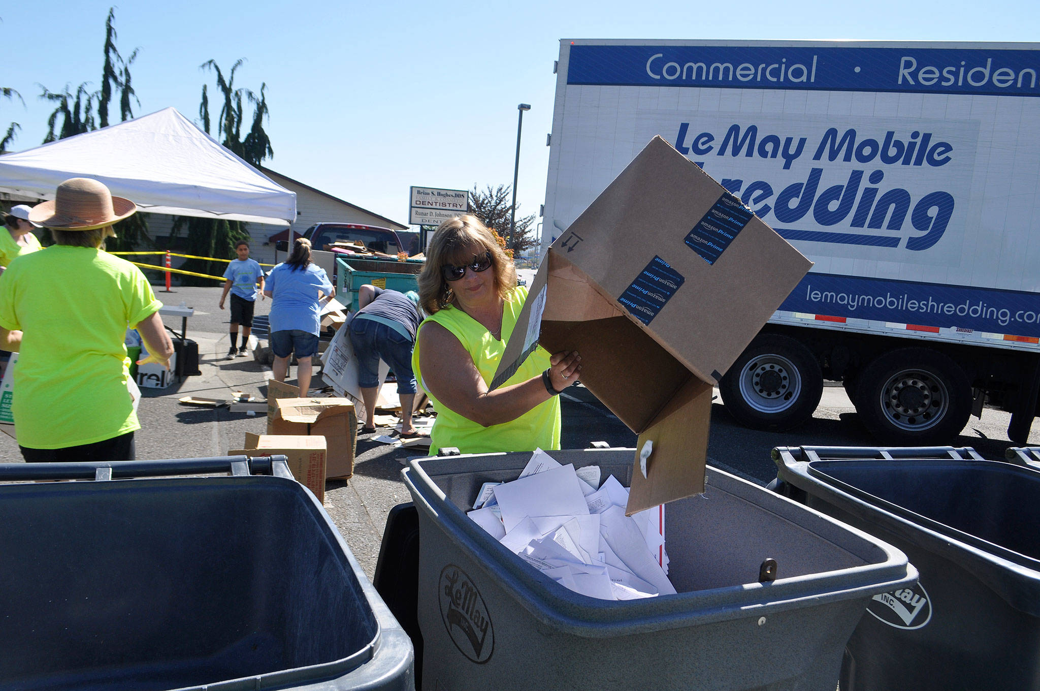 Christy Francis with Castell Insurance dumps documents for shredding at Castell Insurance’s annual shred event. This year, organizers host the free event with no limit from 8 a.m.-11 a.m. Saturday, Aug. 11, with monetary and school supply donations supporting the Boys & Girls Club’s Back to School Fair. Submitted photo