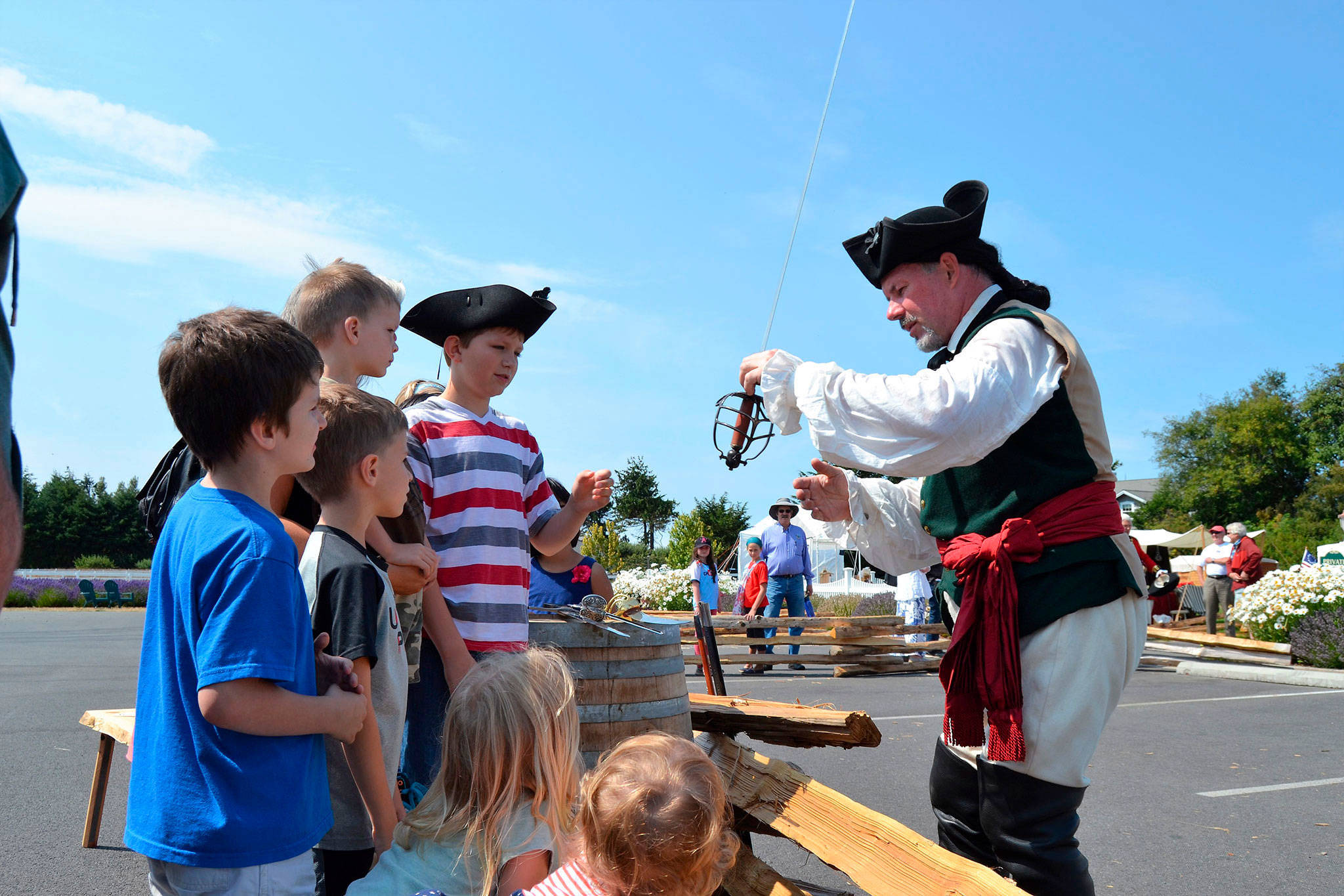 David Wine as Lt. Peter Ten Brock speaks with children at last year’s Northwest Colonial Festival in front of the George Washington Inn about different swords from the time period and before. This year’s event features more sword fight reenactments and discussions.                                 Sequim Gazette file photo by Matthew Nash