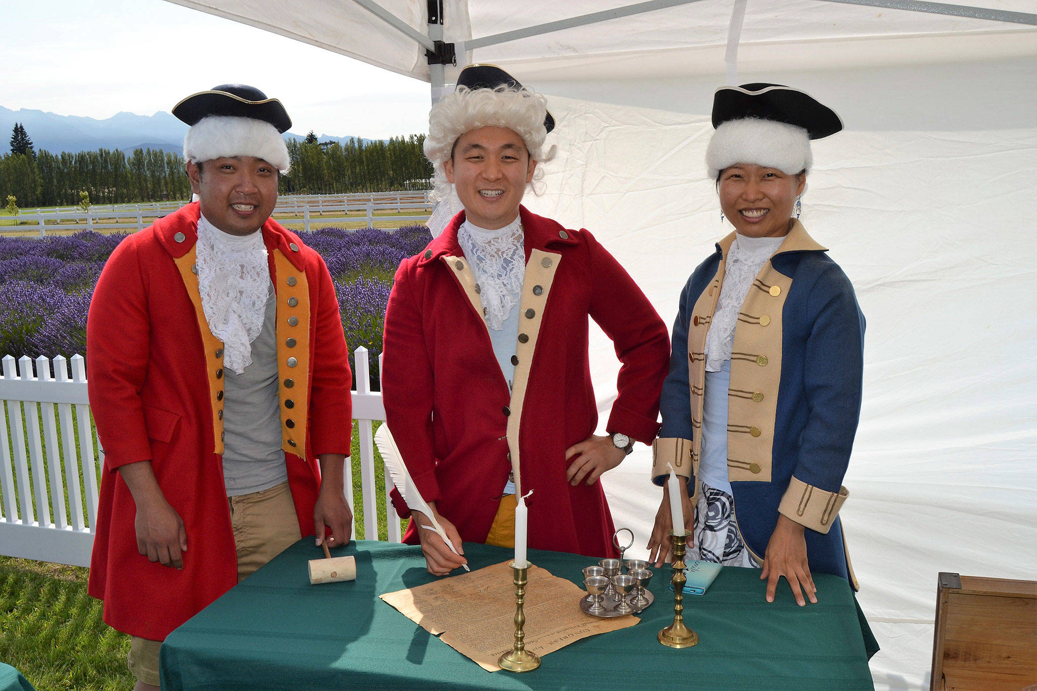 Friends from Seattle, from left, Peter Cher, Jung Jim and Jin Lim dress the part for a photo-op as they prepare to sign the Declaration of Independence at the 2017 Northwest Colonial Festival. Visitors can dress in colonial clothes at this year’s event on Aug. 9-12, too.                                 Sequim Gazette file photos by Matthew Nash