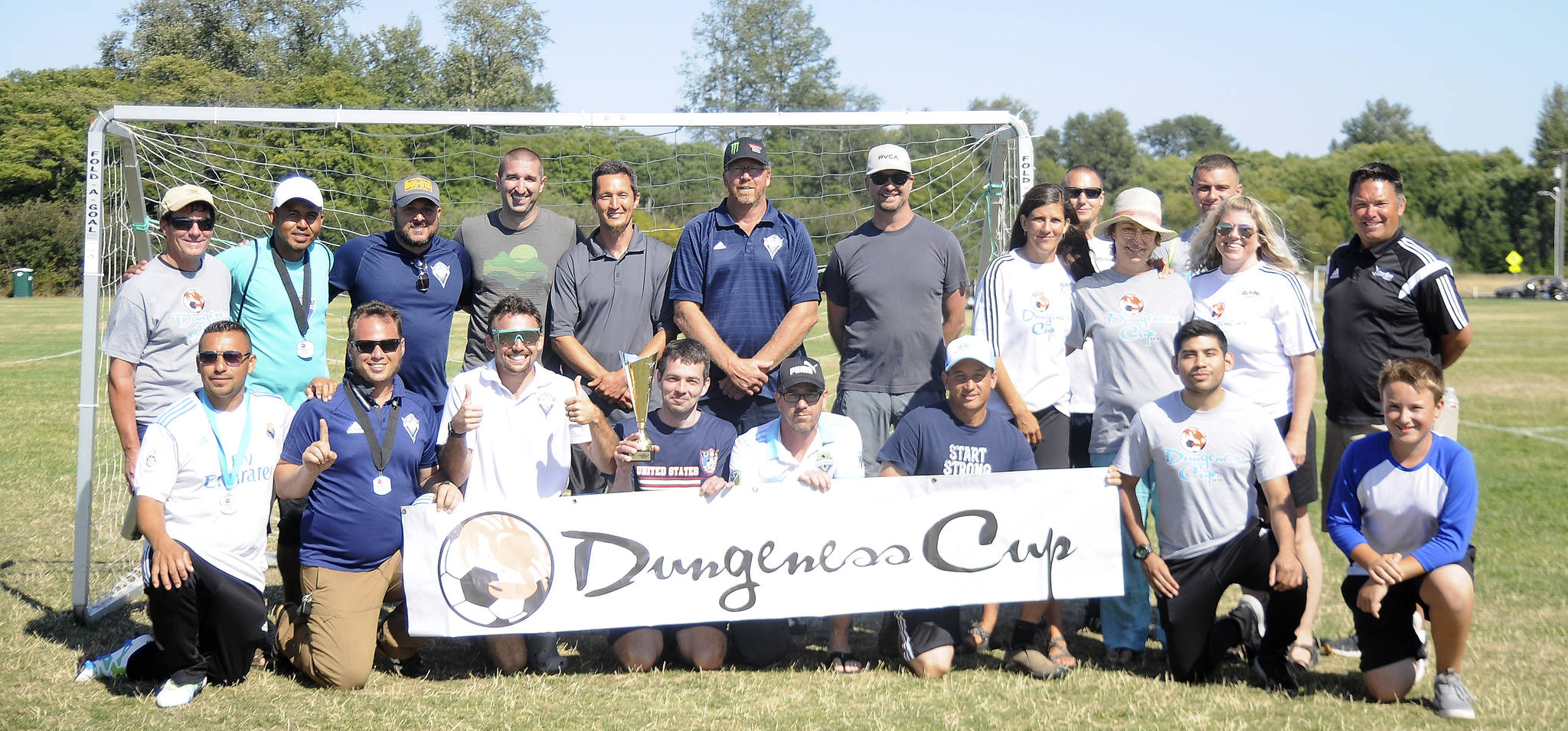 Organizers and coaches at the 2018 Dungeness Cup are all smiles following championship games that rounded out the three-day tournament on Aug. 5. Sequim Gazette photo by Michael Dashiell