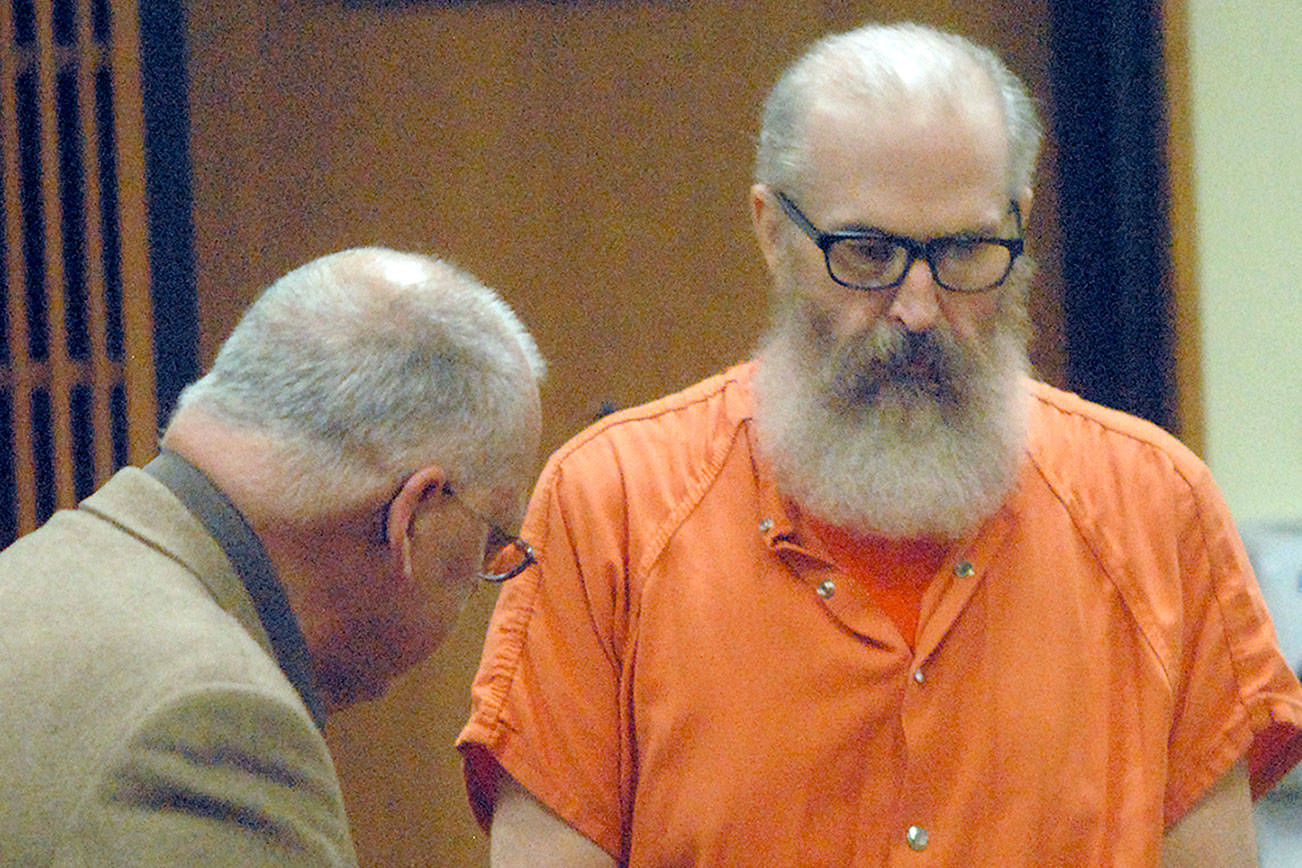 Douglas Allison, right, is ushered to his chair by Clallam County public defender Harry Gasnick during Allison’s sentence hearing in 2016 in Clallam County Superior Court in Port Angeles. He received 26-and-a-half years in prison. One of his victim’s families is suing his former school for damages because they believe the church’s corporation knew about previous allegations prior and during his employment. File photo by Keith Thorpe/Peninsula Daily News