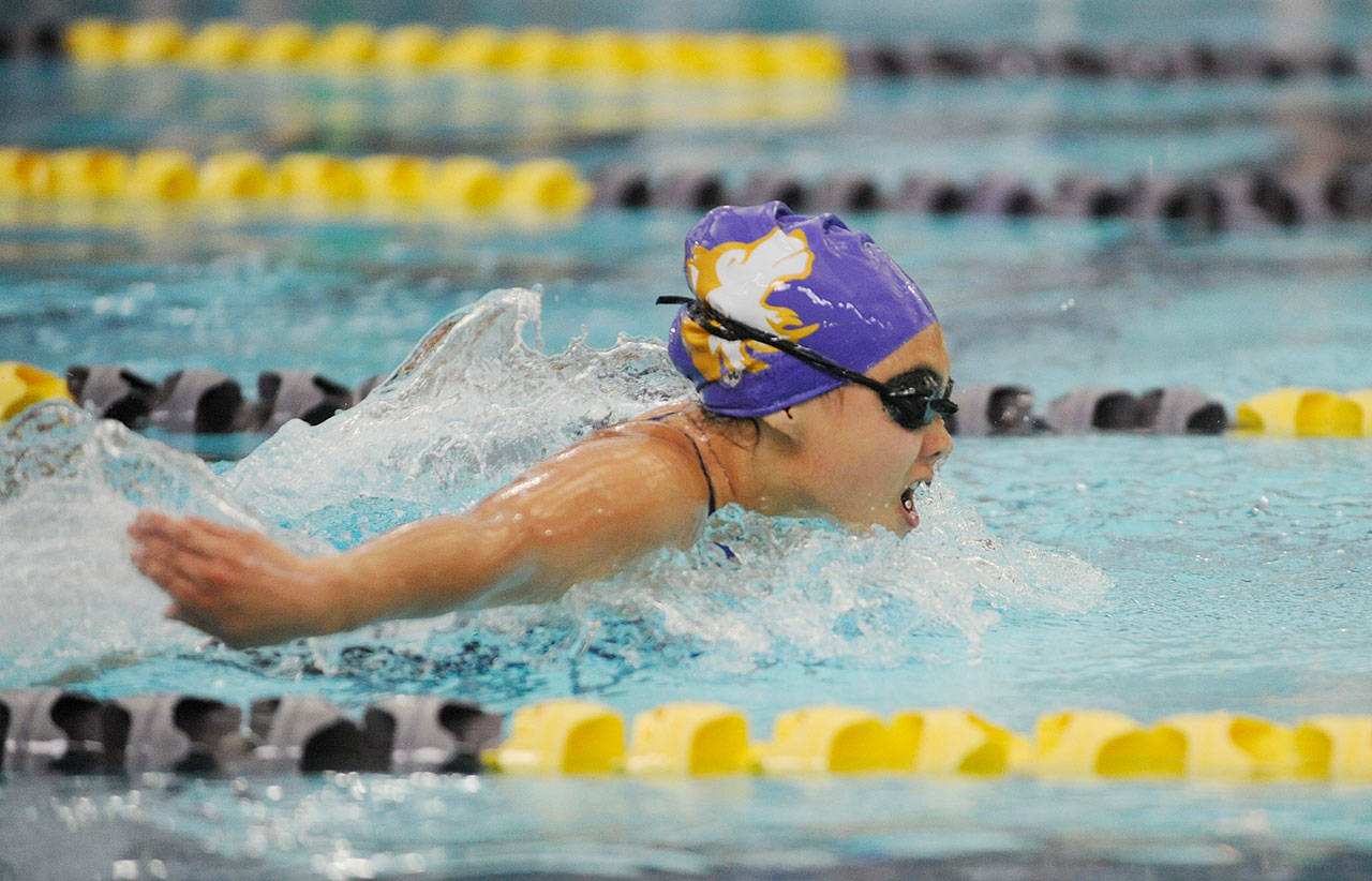 Anna Price of Sequim splashes to a strong finish in the 100 butterfly as the Wolves take on Olympic on Sept. 11. Sequim Gazette photo by Michael Dashiell