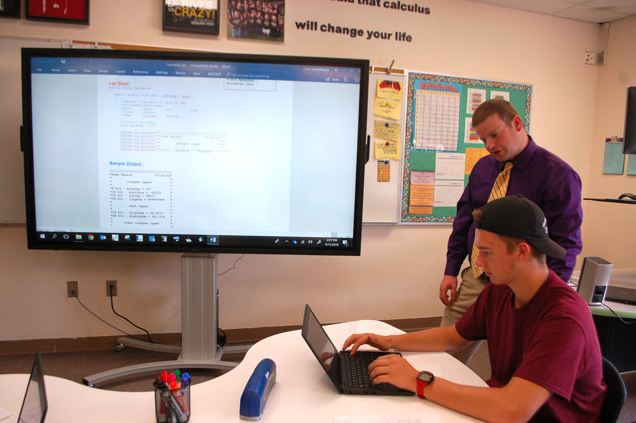 Teacher Jorn VandeWeghe helps Jordan Hurdlow, and advanced placement computer science student, during a variables lab on Sept. 13 at Sequim High School. AP computer science is a new course offered at the high school this year after the district received a grant in May to purchase technology to teach the course and acquiring curriculum to create a K-12 computer science pathway. VandeWeghe said his students focus on problem-solving, creativity, and using and creating technology in writing applications that solve human problems. Students take an AP exam later in the year when they can earn college or course credit. Sequim Gazette photo by Erin Hawkins