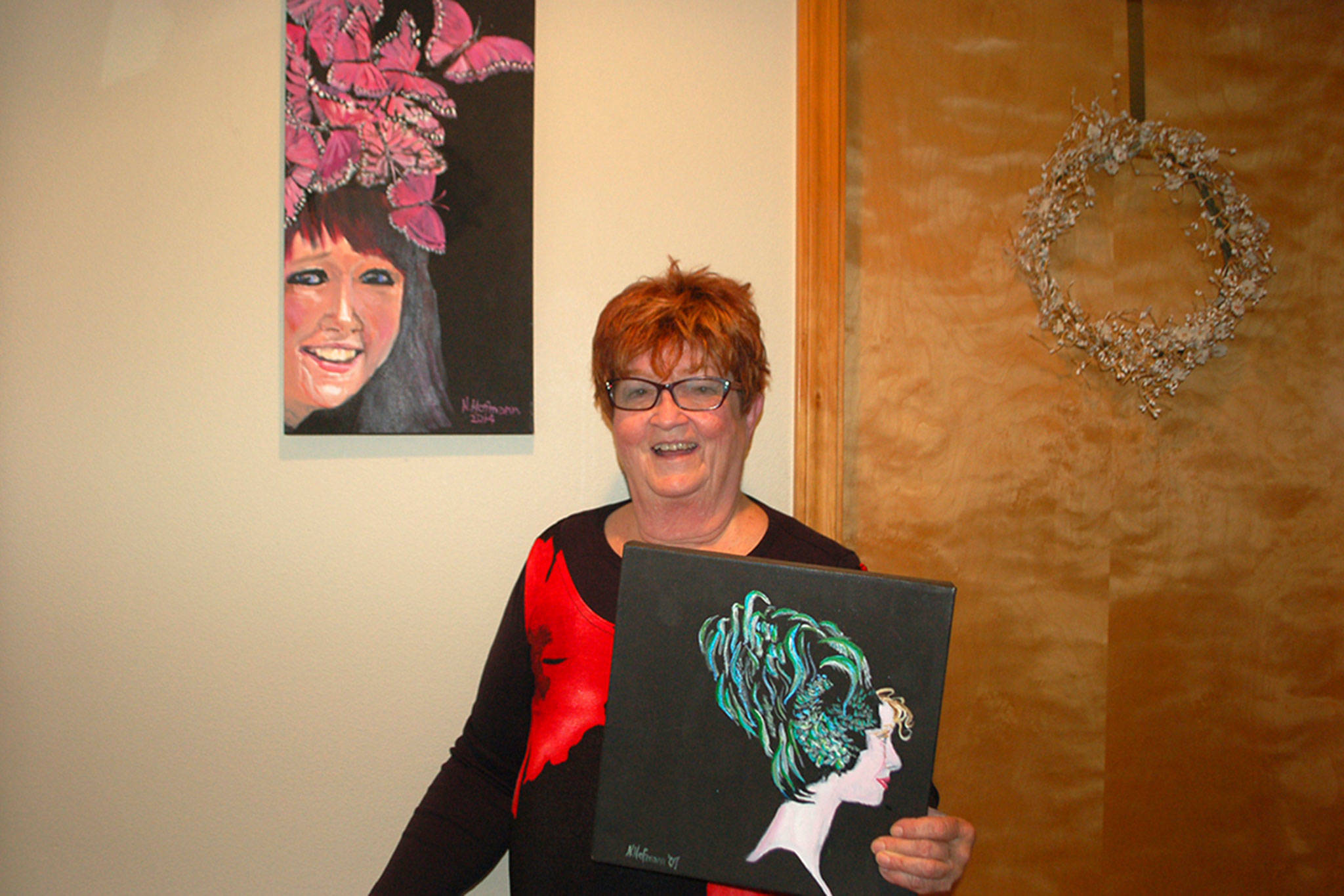 Above: Nancy Hofmann is a two-time breast cancer survivor and Mad Hatter’s Tea Party committee member. She has attended the annual fundraising event for 20 years and enjoys painting her favorite hats she seen over the years.                                 Right: Nancy Hofmann’s painting of her and her sister. Both are breast cancer survivors. Sequim Gazette photo by Erin Hawkins