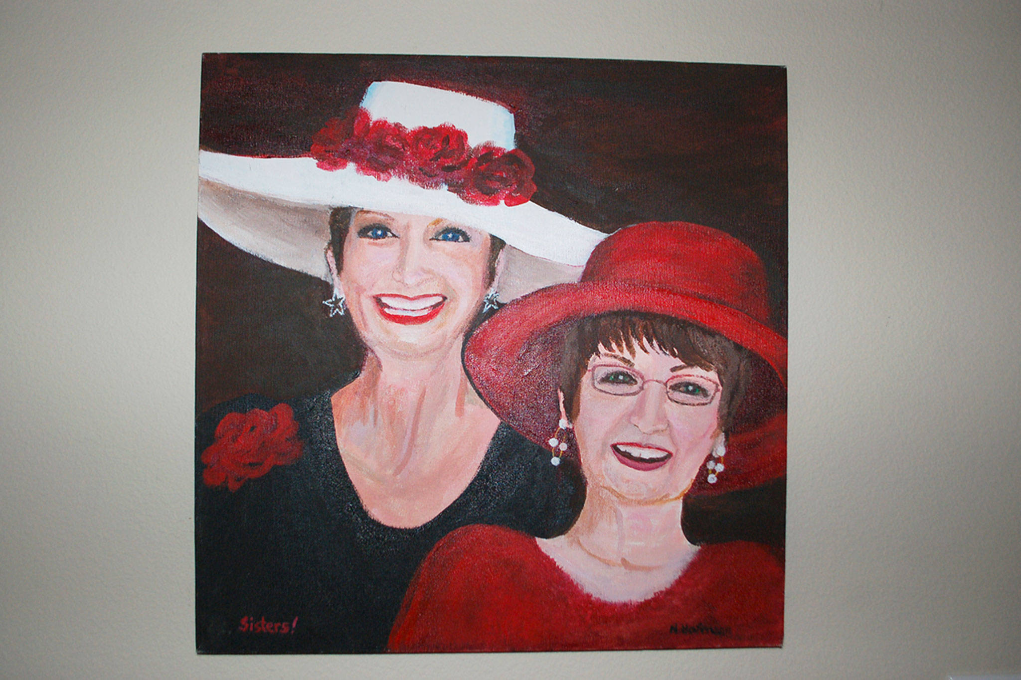 Sequim’s Nancy Hofmann painted a picture of her and her sister based on a photo of them wearing hats together at a Mad Hatter’s Tea Party. Both sisters are breast cancer survivors. Sequim Gazette photo by Erin Hawkins