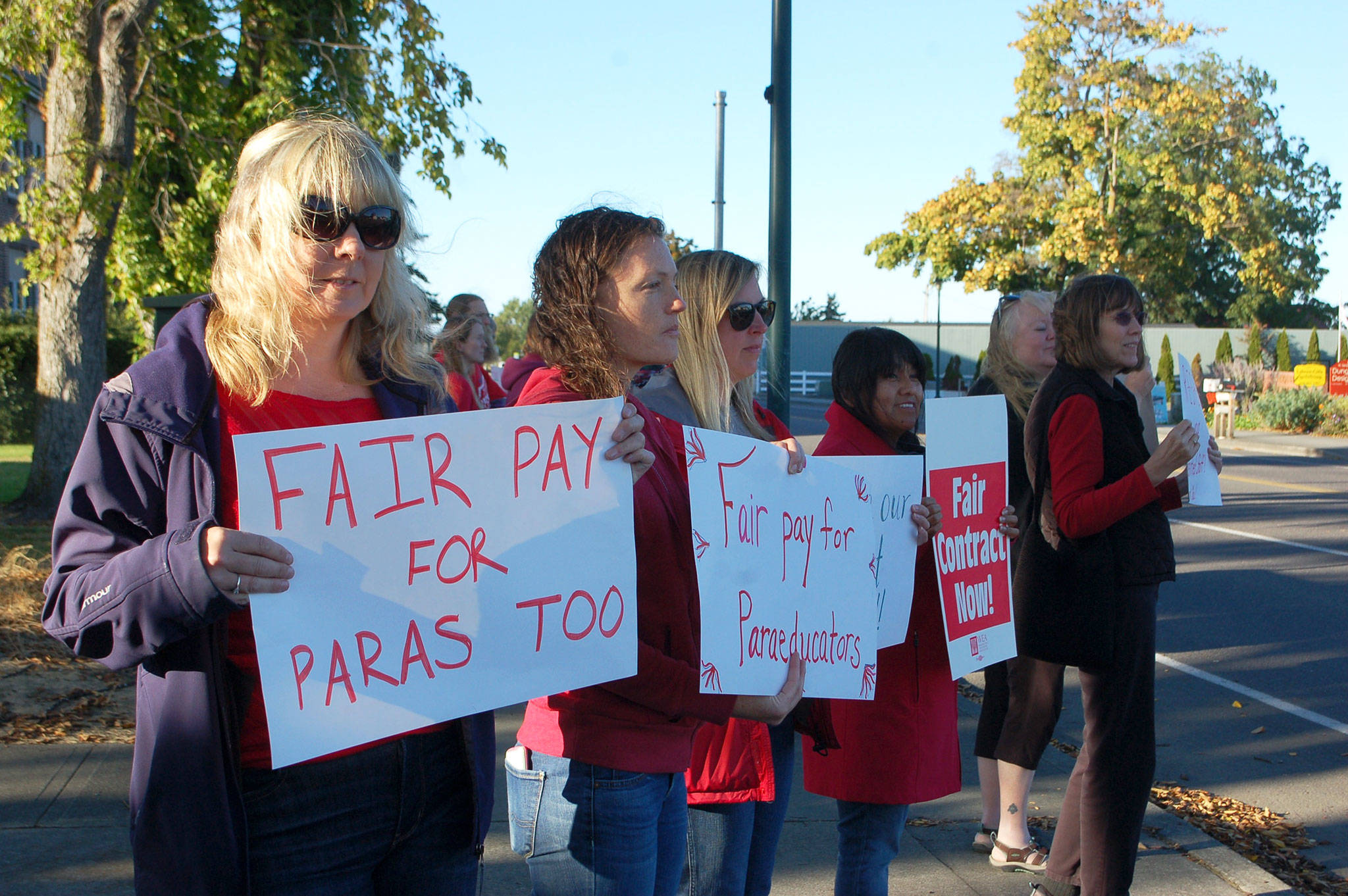 Paraeducators from Helen Haller Elementary School, from left, Veronica Catelli, Stephanie Dormer, Sarah Sullivan and Monica Gonzalez gather along the corner of N. Sequim Avenue and West Fir Street with other paraeducators to lobby for equitable salaries on Sept. 17. Sequim Gazette photo by Erin Hawkins                                Paraeducators from Helen Haller Elementary School, from left, Veronica Catelli, Stephanie Dormer, Sarah Sullivan and Monica Gonzalez gather along the corner of N. Sequim Avenue and West Fir Street with other paraeducators to lobby for equitable salaries on Sept. 17. Sequim Gazette photo by Erin Hawkins