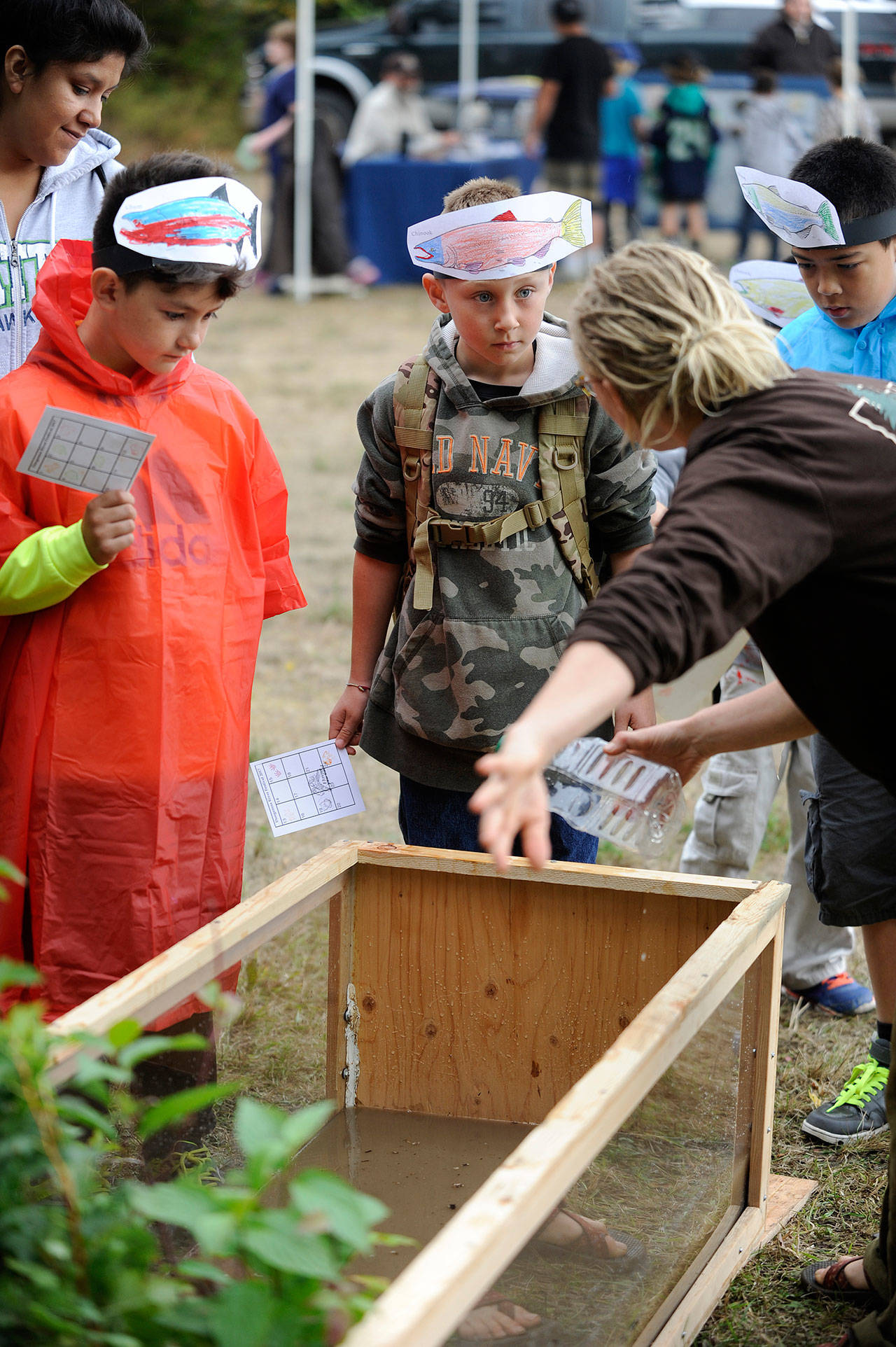 Greywolf Elementary students, from left, Adan McCaughan, Coletyn Hull, and Andonios Iott in Shannon Green’s third grade class listen in on one of the many booths at the Dungeness River Festival last year.                                 Sequim Gazette file photo by Michael Dashiell