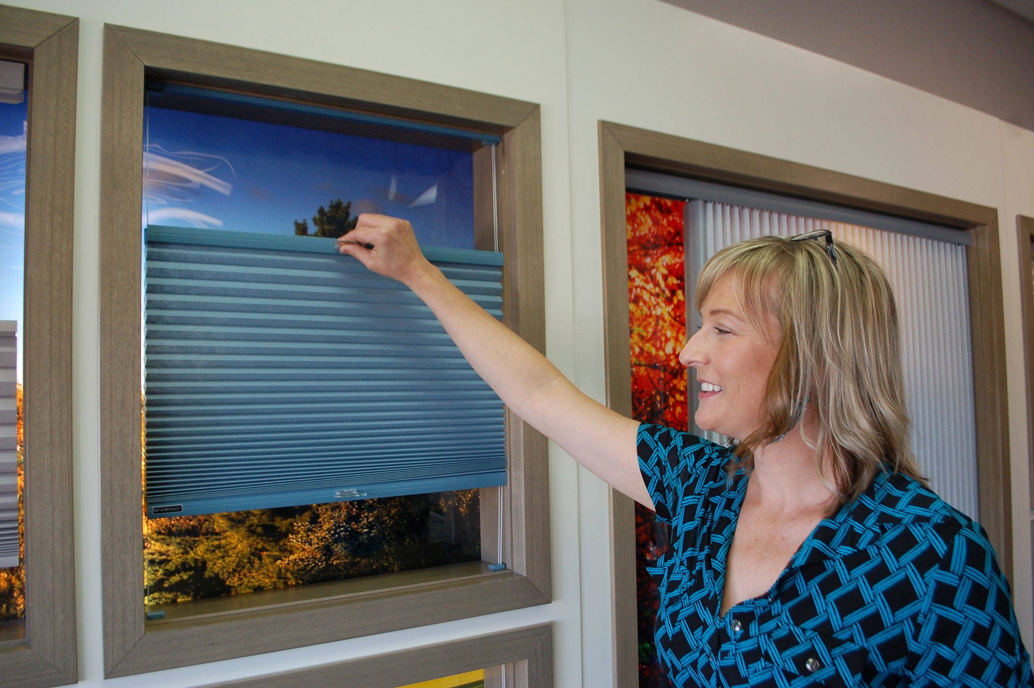 Alicia Ennen, window covering consultant at The Blind Store by McCrorie, shows how one of the store’s top-down bottom-up cellular shades work and can be adjusted from the top or bottom of the shade. Sequim Gazette photo by Erin Hawkins