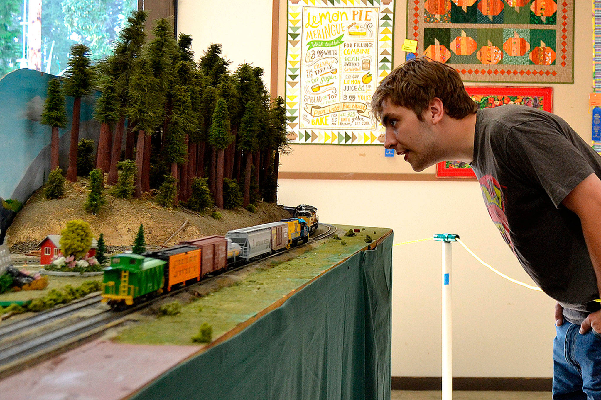 During the Clallam County Fair in August, Sequim’s Billy Edwards inspects the North Olympic Peninsula Railroaders’ HO-scale display saying, “This thing is so sweet. It has so much detail.” The club hosts its 19th show at the fairgrounds on Oct. 13-14. Sequim Gazette file photo by Matthew Nash