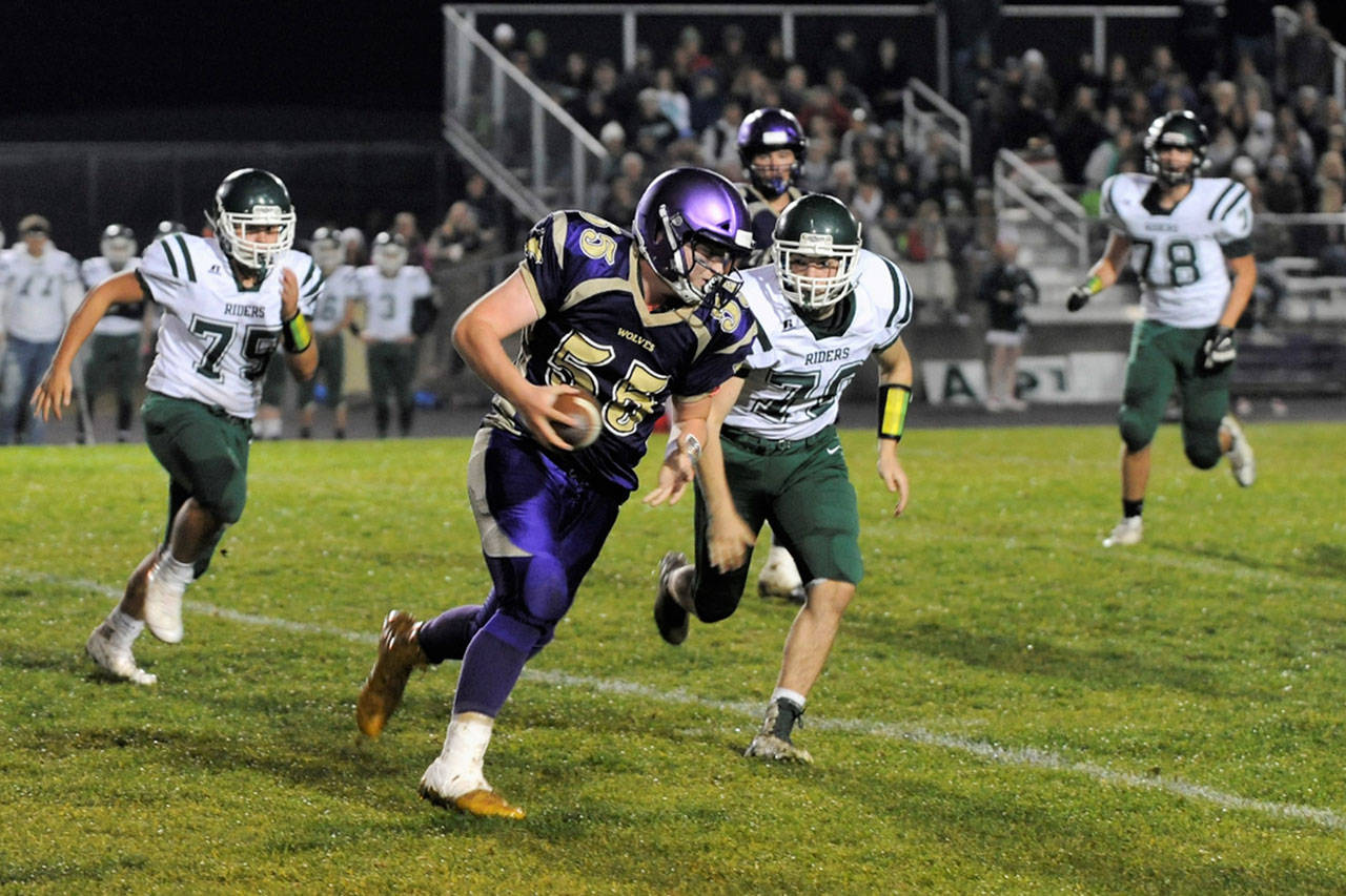 Sequim lineman Brandon Barnett looks for running room after picking off an errant throw from Port Angeles quarterback Brenden Roloson-Hines in the Wolves’ 46-6 rout on Oct. 12. Sequim Gazette photo by Matthew Nash
