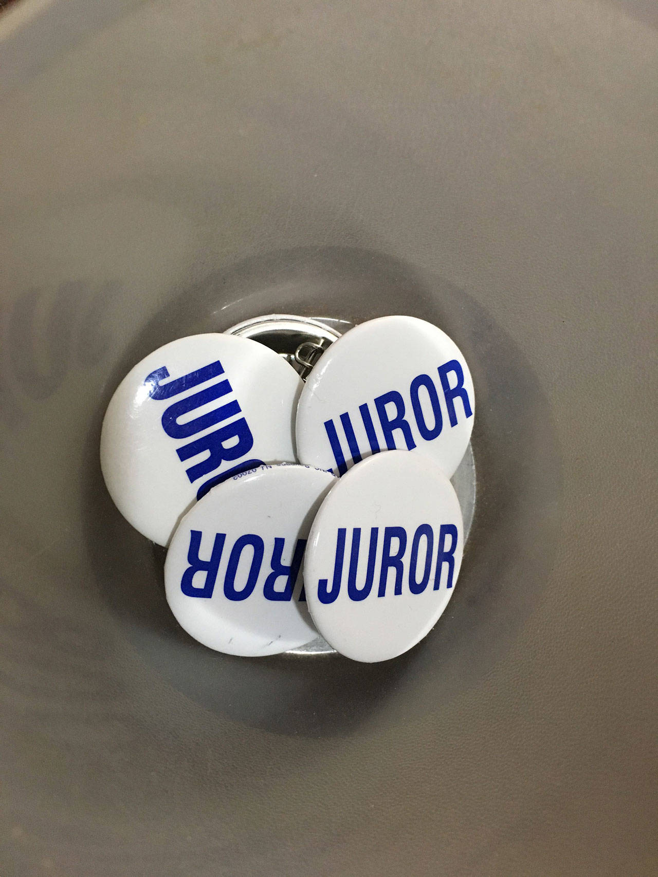Clallam County jurors must wear a pin inside the courthouse and not talk to anyone other than jurors or courtroom staff. They ask you return the pin, too. Sequim Gazette photo by Matthew Nash