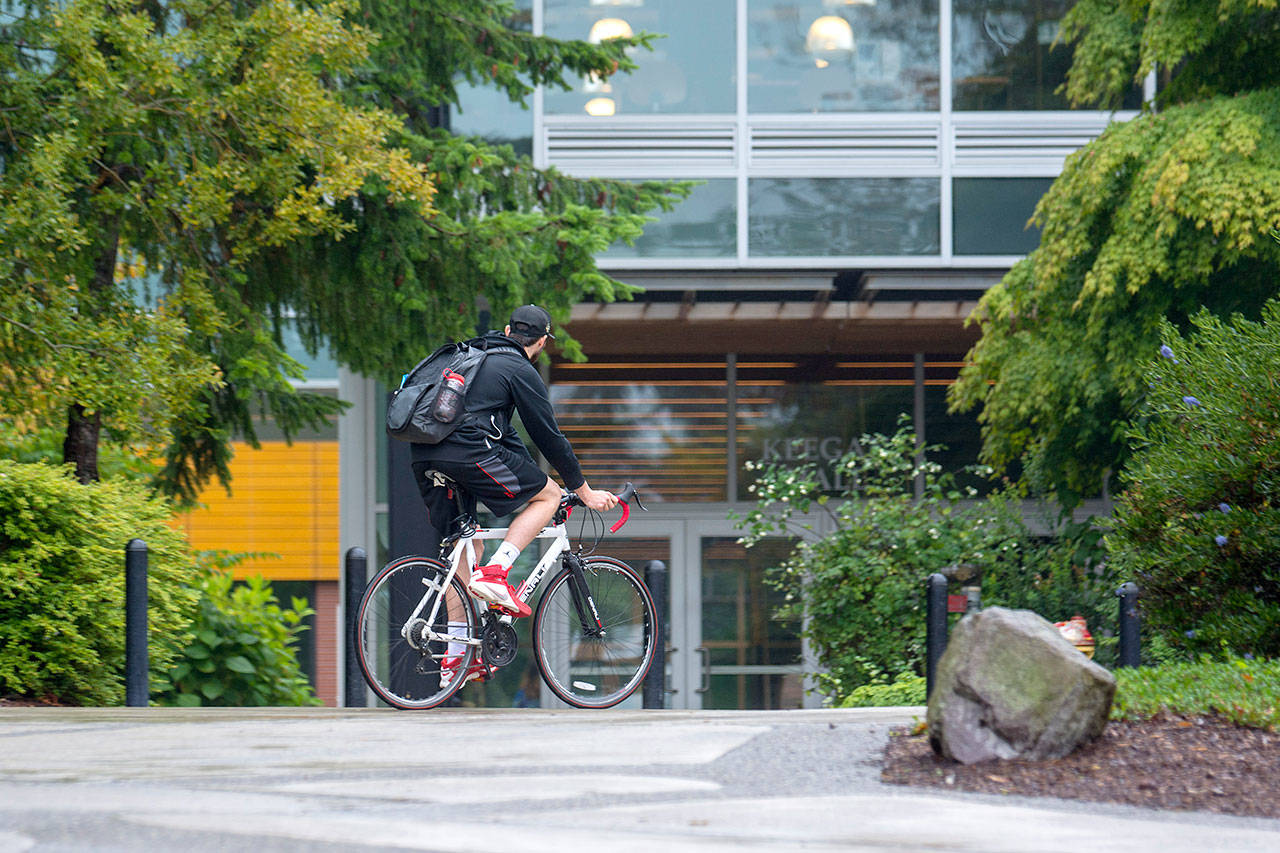 A cyclist makes his way across the Peninsula College campus in Port Angeles last week. Peninsula College announced Monday it will receive a $2.2 million grant from the federal Department of Education. Photo by Jesse Major/Peninsula Daily News