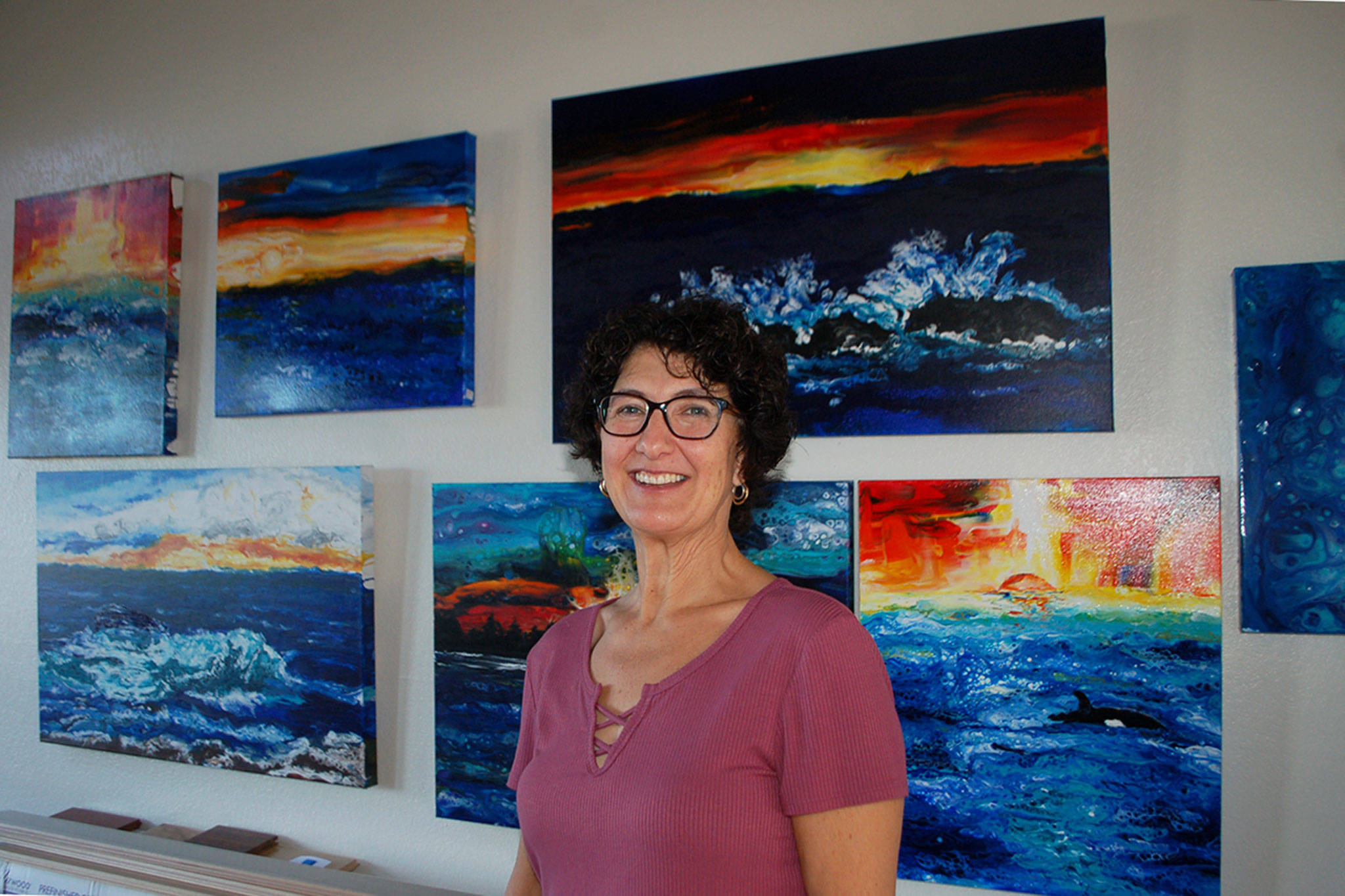 Melanie Burns is a self-taught artist that believes “art is meditation.” She discovered acrylic pouring in January and has loved the medium ever since, as seen on the walls of her Sequim home where several of her paintings hang. Sequim Gazette photo by Erin Hawkins