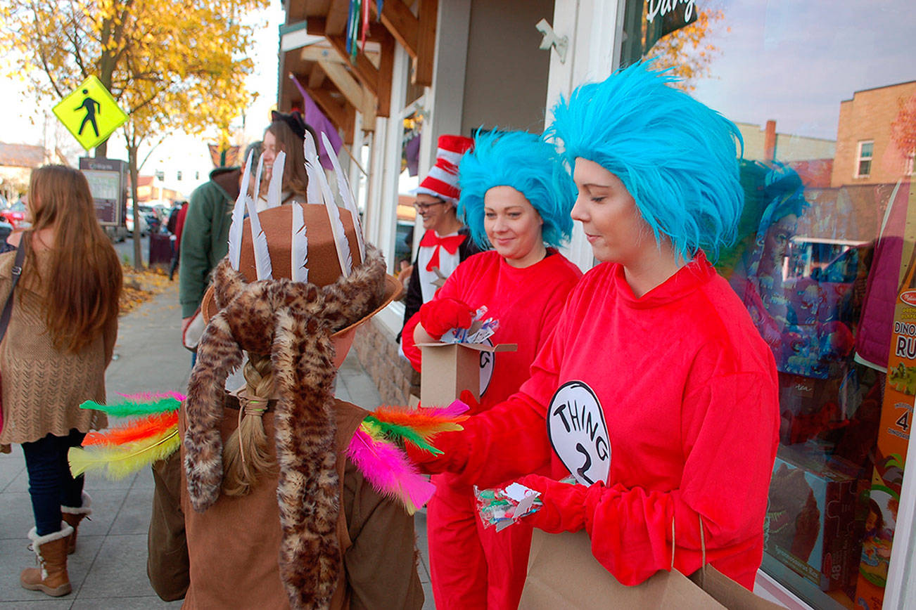 Marissa Santjer (Thing 1) and Anna Santjer (Thing 2) hand out candy during last year’s Merchant Trick or Treating event downtown last year. The event continues this year from 3-5 p.m. Wednesday, Oct. 31. Sequim Gazette file photo by Erin Hawkins