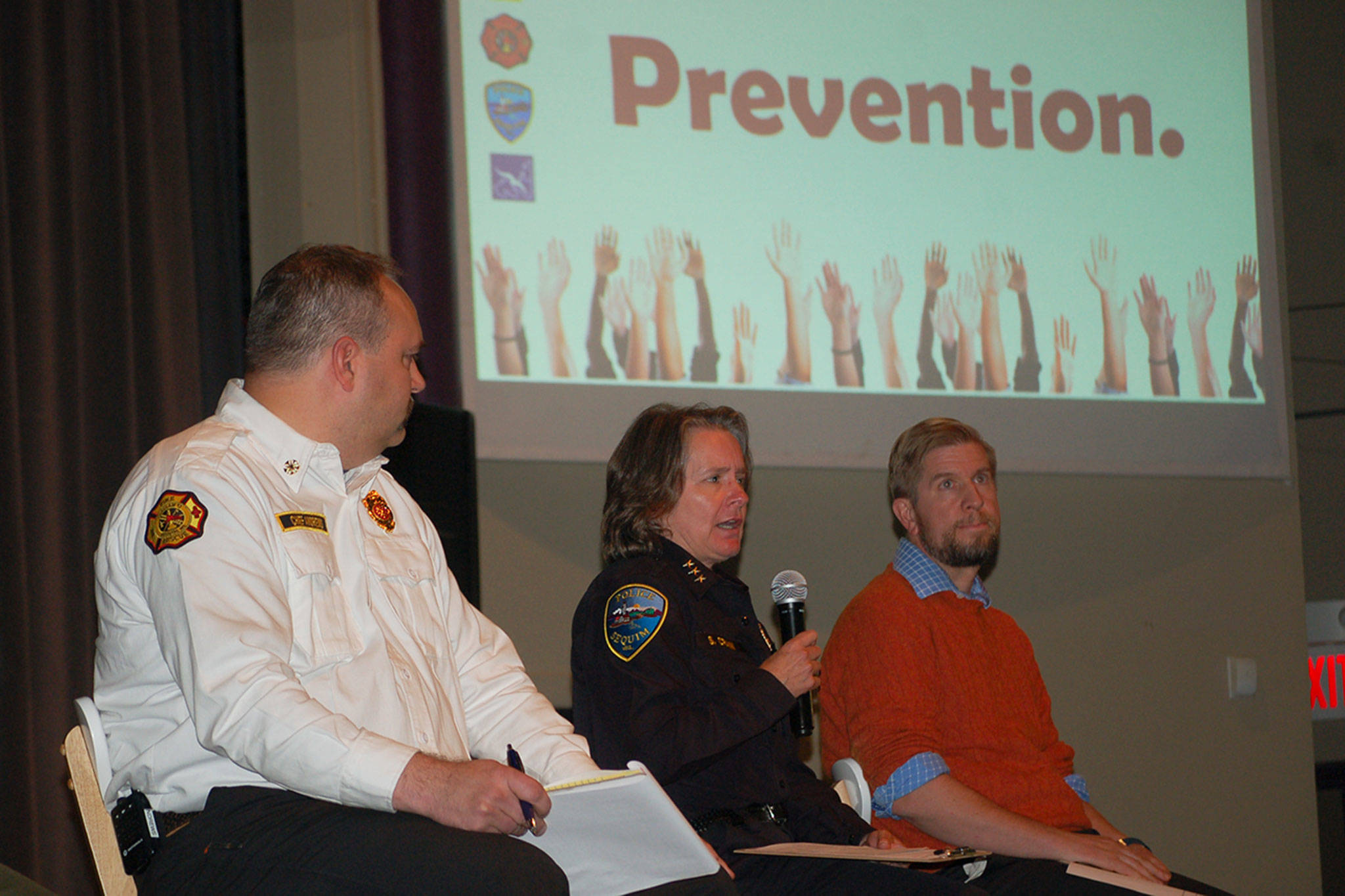 Clallam County Fire District 3 Chief Ben Andrews, left, and City manager Charlie Bush, right, listen as Sequim Police Chief Sheri Crain discusses how the police department tackles prevention methods for community emergencies. Sequim Gazette photo by Erin Hawkins