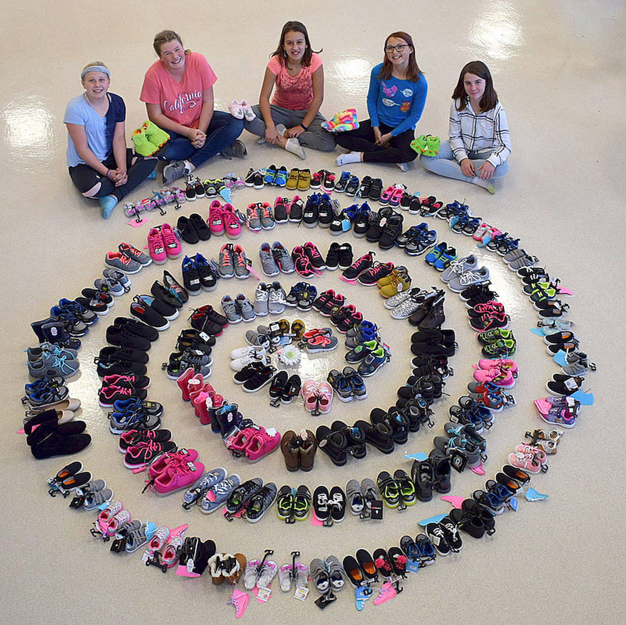Girl Scouts with Troop 45181, from left, Adrianna Delph, Paige Krzyworz, Mia Kirner, Alexys Amaya and Izzy Taylor helped bring in more than 130 pairs of new shoes for Clallam County foster children through a recent shoe drive. Not pictured are Desirea and Mya Spalding. See story on Page 11. Submitted photo
